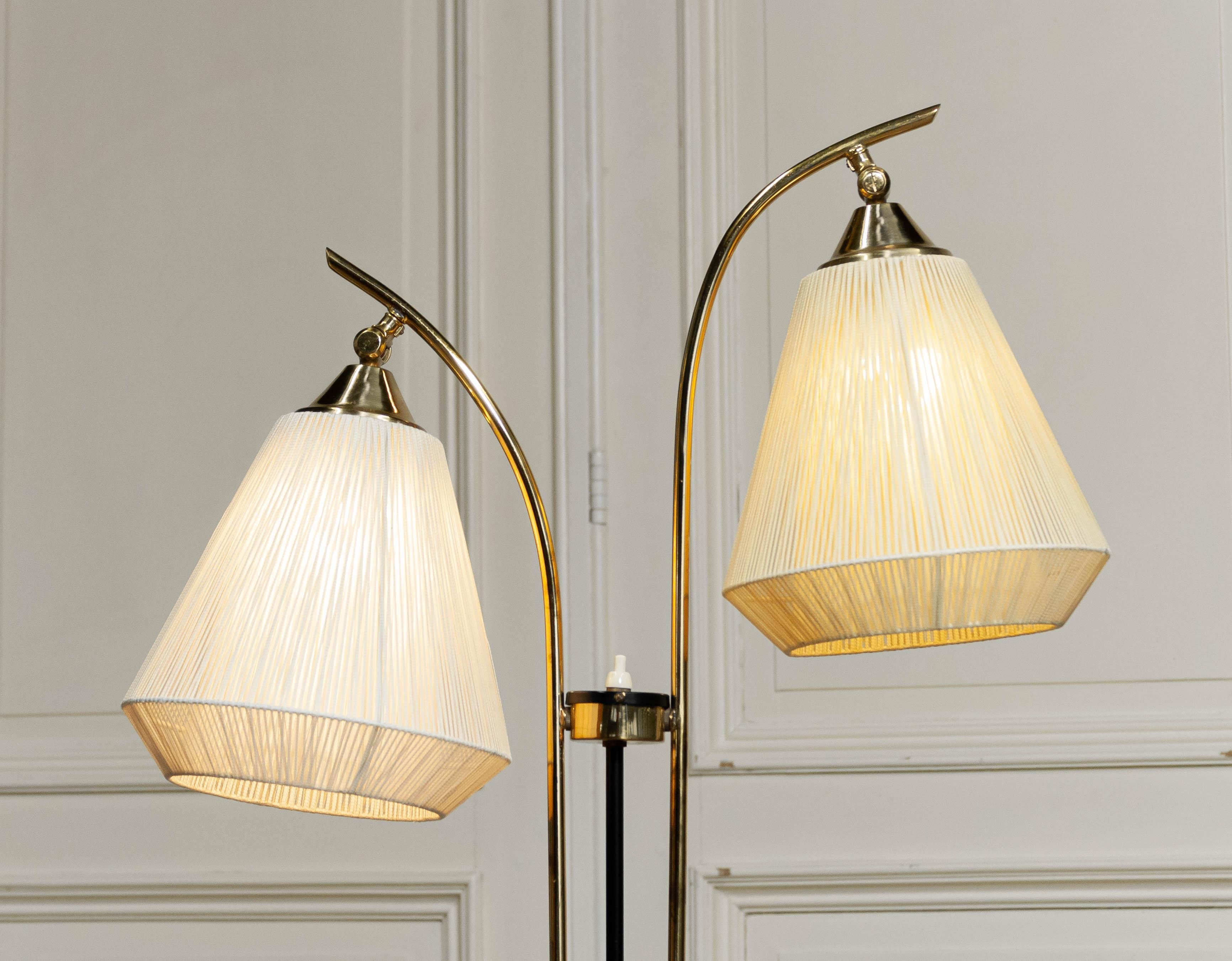 Elegante Stehlampe aus der Mitte des Jahrhunderts von dem bekannten dänischen Designer Svend Aage Holm-Sørensen, aus den 1950er Jahren. Diese raffinierte Leuchte verfügt über einen doppelten Messingschaft mit anmutig geschwungenen Armen, die jeweils
