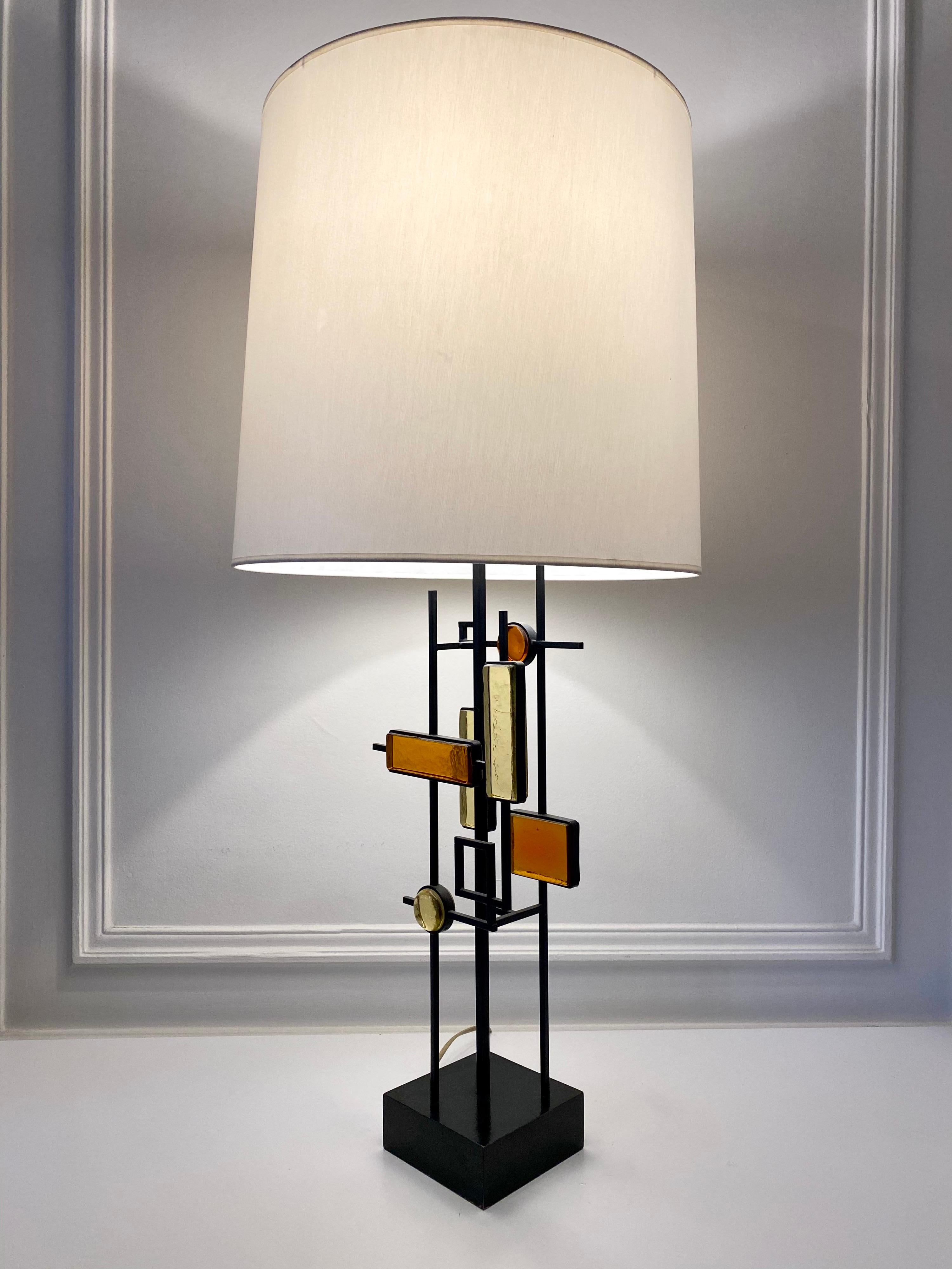 Table lamp designed by Svend Aage Holm Sørensen. Black lacquered iron stem with geometric colored glass pieces and black lacquered wood base.
Svend Aage Holm Sorensen (1913-2004) was a Danish designer who is best known for his wide collection of