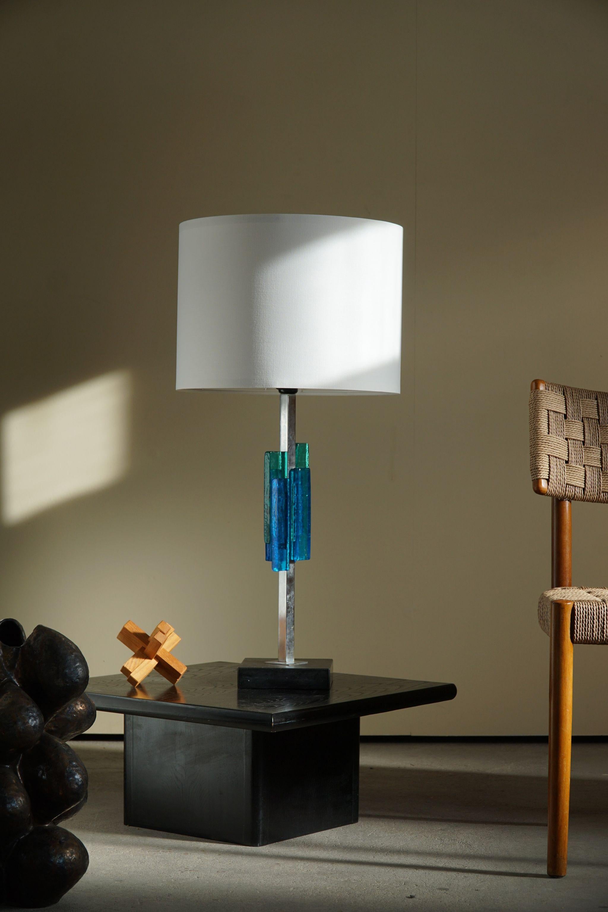 Table lamp in metal and glass in various blue colors. Designed by Svend Aage Holm Sørensen for hes own company in 1960s.

This piece is in a really good vintage condition.

Perfectly suited for any home decor. It would fit in any modern,