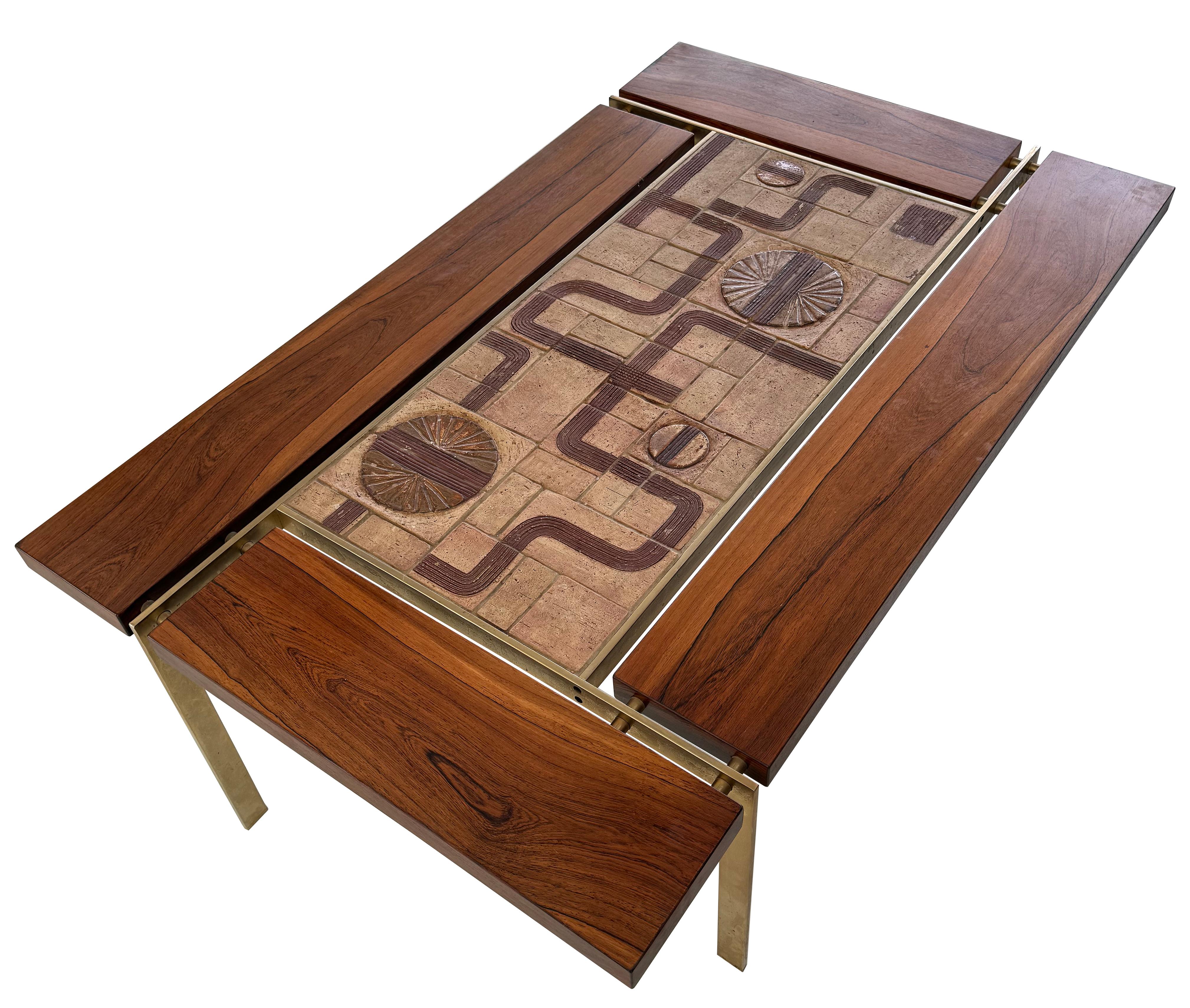 An incredible large coffee table in rosewood and brass by Svend Aage Jessen ca. 1965.     This table has incredible presence and scale.  Rosewood segments are attached with solid brass spacers surrounding a large hand- made Sejer Tile middle.   This