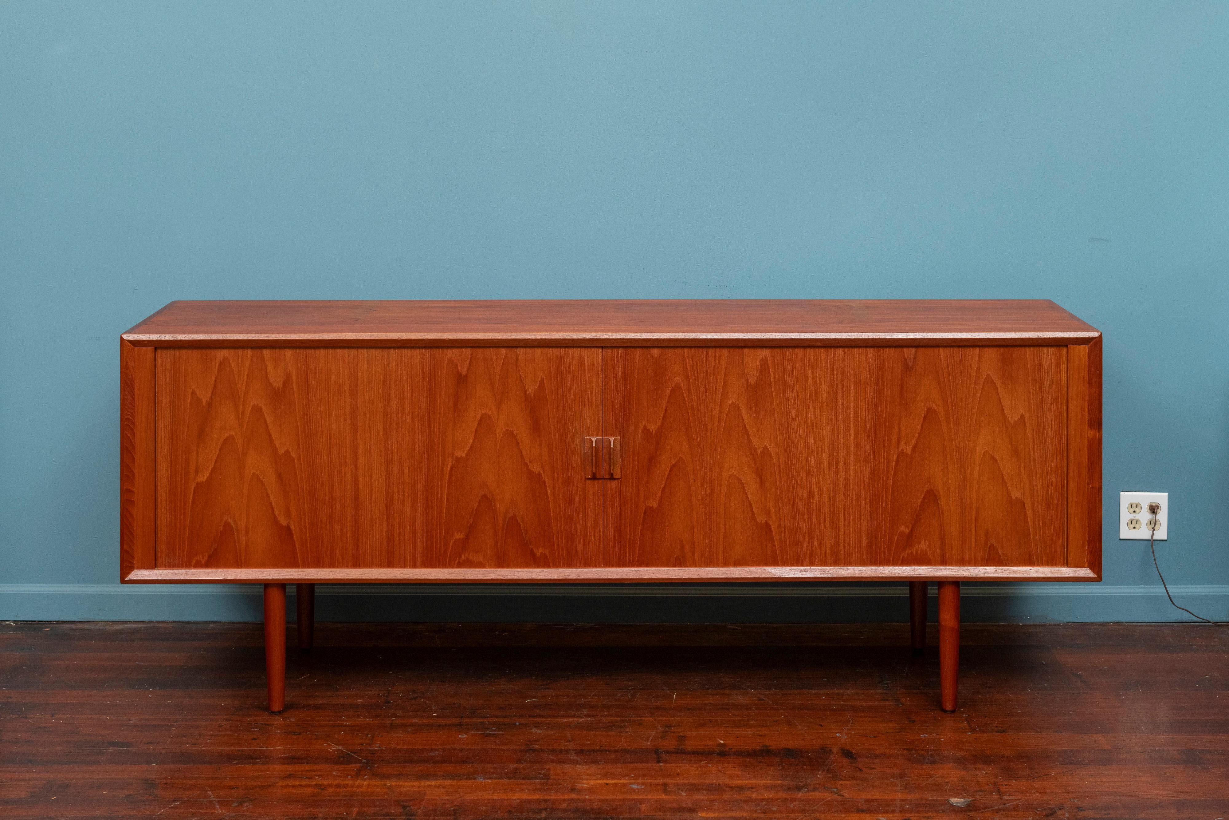 Svend Aage Larsen design teak credenza for Faarup Mobelfabrik, Denmark. Sophisticated clean lines and amazing tambor doors that reveal a fitted interior comprising adjustable shelves and drawers. High quality construction and materials used