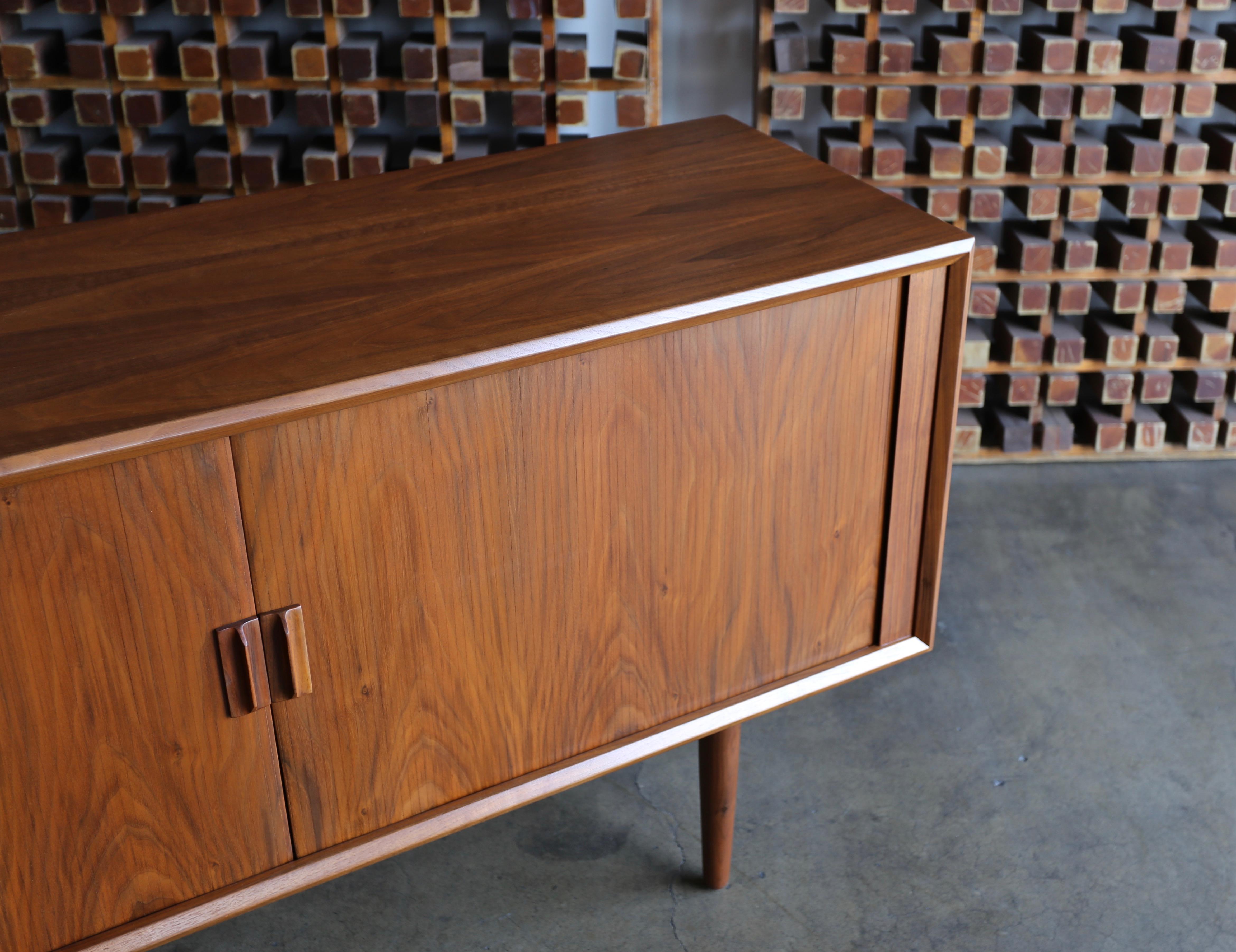 Svend Aage Larsen walnut tambour door credenza for Faarup Mobelfabik, Denmark, circa 1965. This piece has been professionally restored. Finished back.