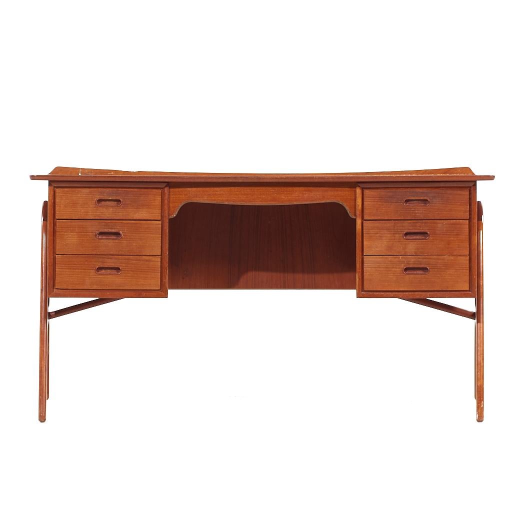 Svend Aage Madsen for Sigurd Hansen Mid Century Curved Front Teak Desk

This desk measures: 59 wide x 28.5 deep x 28.5 high, with a chair clearance of 25 inches

All pieces of furniture can be had in what we call restored vintage condition. That