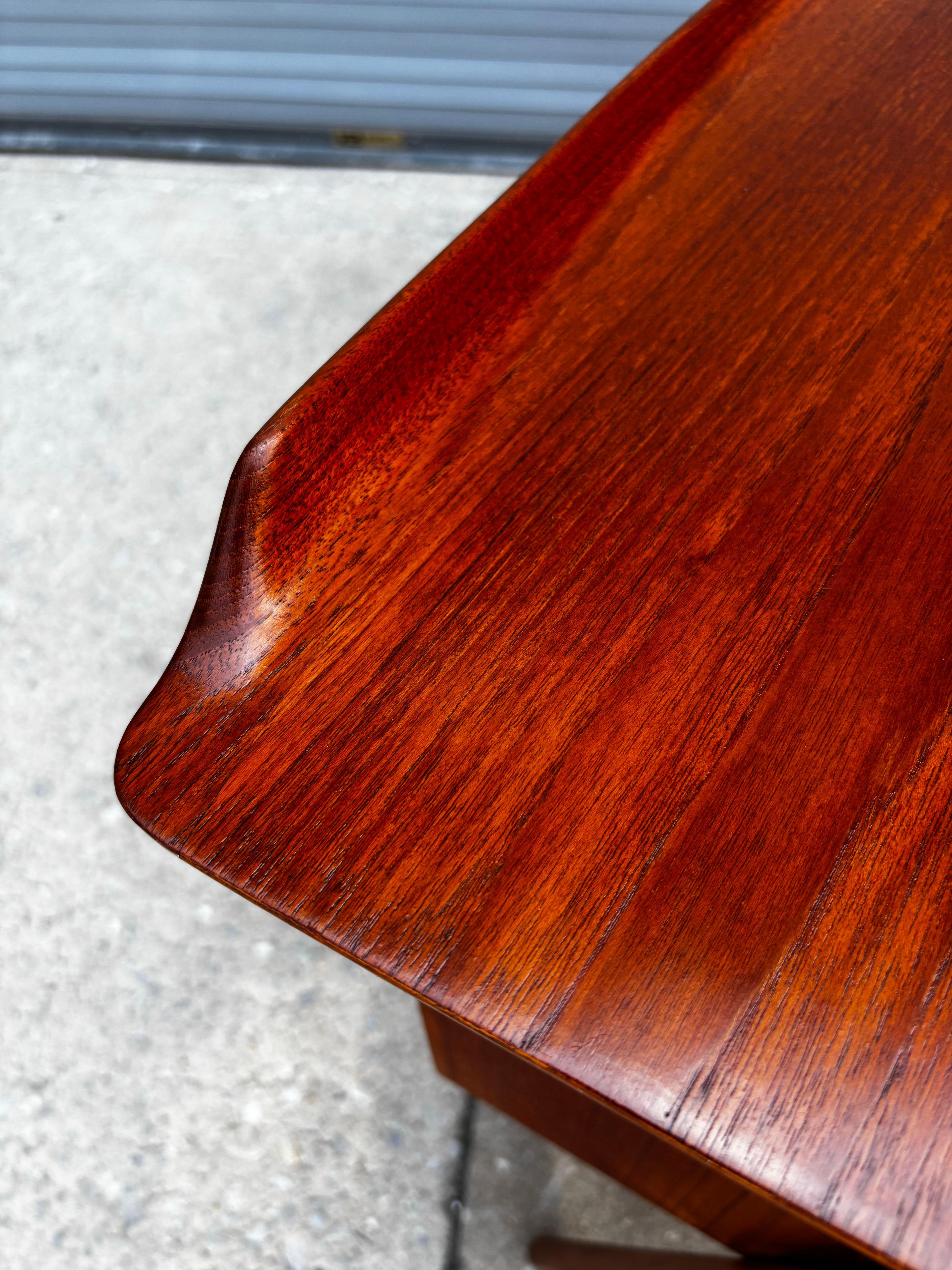 Svend Aage Madsen for Sigurd Hansen teak desk with front bookcase. Desk has a slight graceful curve with a rolled edge to the back of the desk. Beautiful size and scale! Legs are exposed on each end to add to the visual impact of the Desk! Desk top