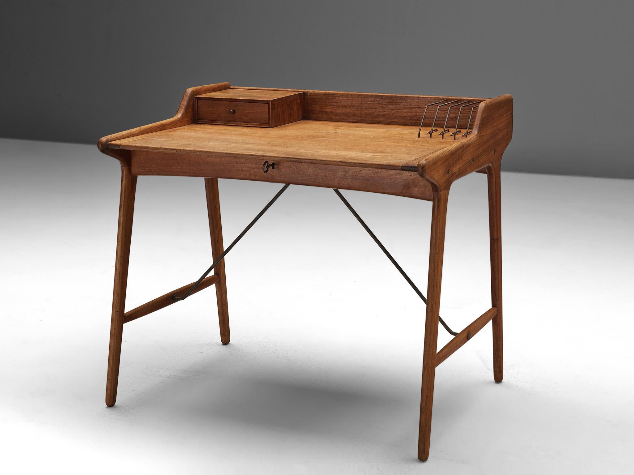 Svend Aage Madsen for K. Knudsen and Son, Desk, brass, teak, Denmark, 1950s.

This refined writing desk is designed by Svend Aage Madsen in the 1950s. The arching top holds a small drawer, and a couple of brass document-holders. Nice and functional