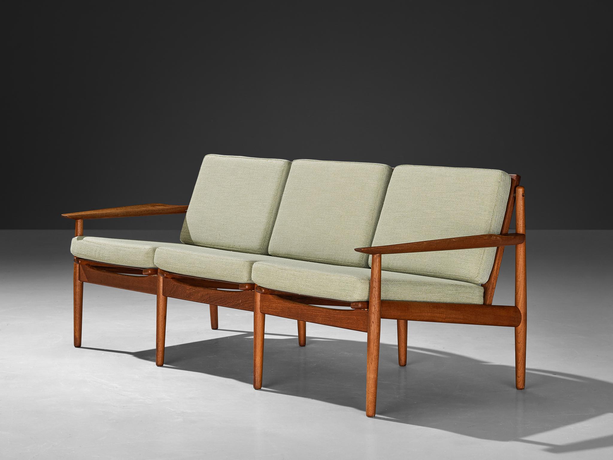 Svend Åge Eriksen for Glostrup Møbelfabrik, sofa, teak, fabric, Denmark, 1960s

Timeless and elegant three-seat sofa created by Danish designer Svend Åge Eriksen in the 1960s. This exquisite piece exemplifies the sophisticated simplicity and