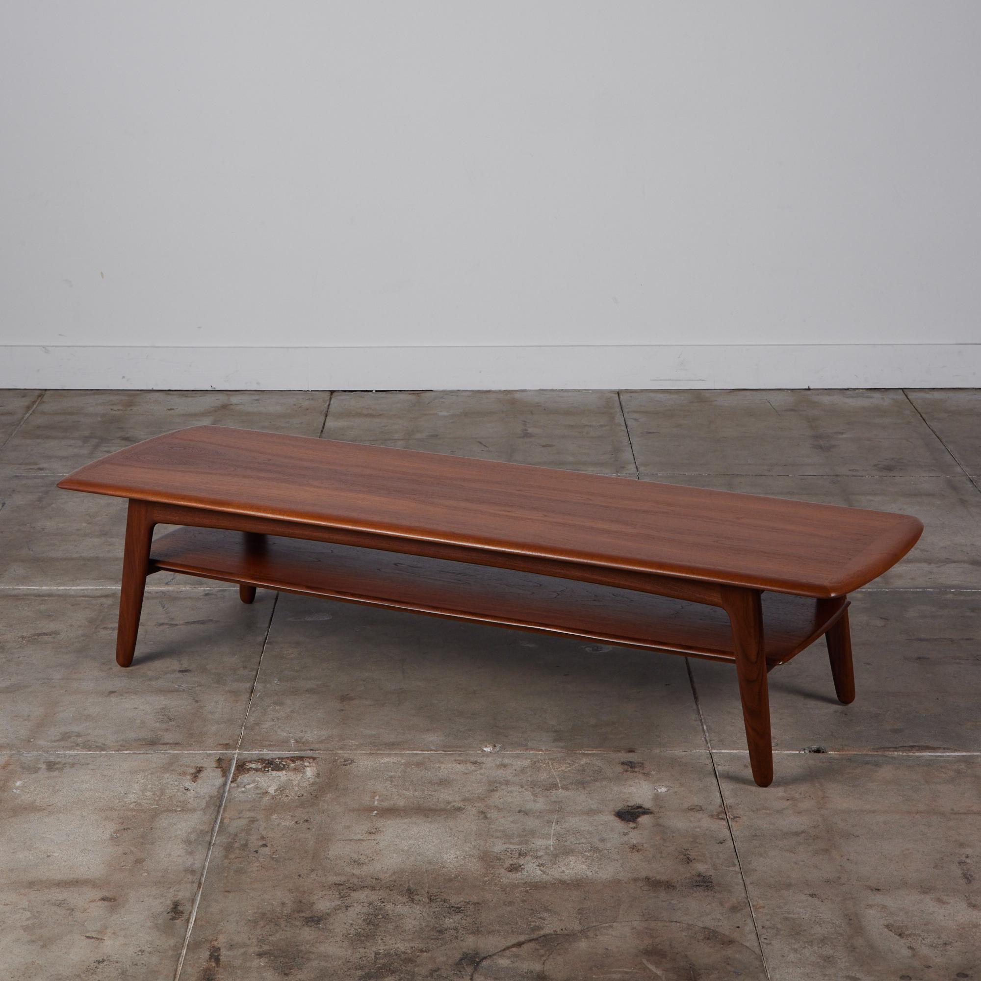 Rectangular coffee table by Svend A. Madsen for Karl Lindegaard, c.1960s, Denmark. The long teak coffee table has slightly rounded corners and is supported by splayed legs. The table boasts a lower shelf to discreetly display magazines or