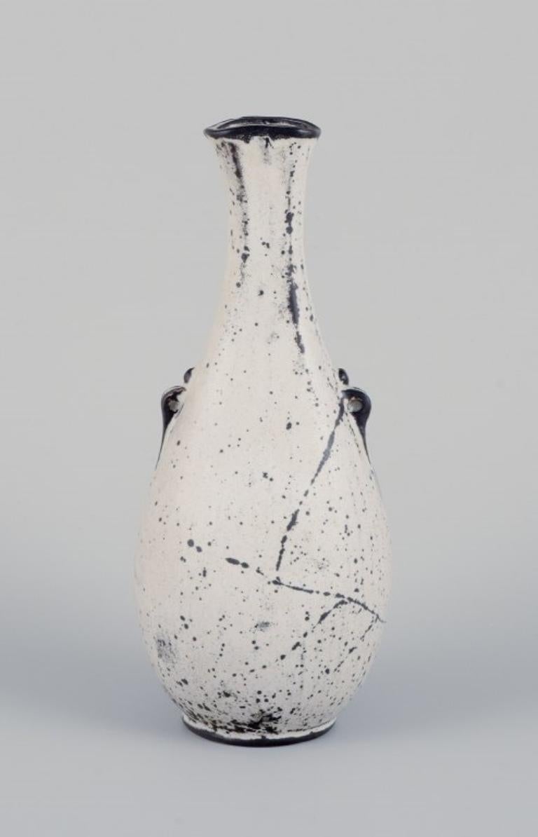 Svend Hammershøi (1873-1948) for Kähler. 
Ceramic vase with a narrow neck in black-grey double glaze.
Ca. 1930.
Marked.
In excellent condition.
Dimensions: Height 20.0 cm x Width 8.0 cm x Depth 7.5 cm.