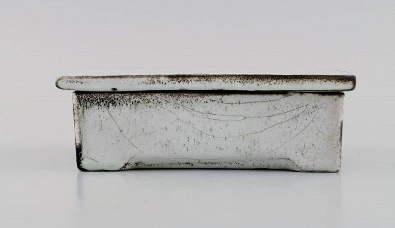 Svend Hammershøi for Kähler, Denmark. 
Box in glazed stoneware. Beautiful gray-black double glaze. 1930s / 40s.
Measures: 14 x 10 x 5 cm.
Stamped.
In excellent condition.