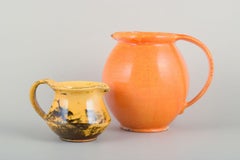 Svend Hammershøi for Kähler. Two ceramic jugs with orange uranium glaze.