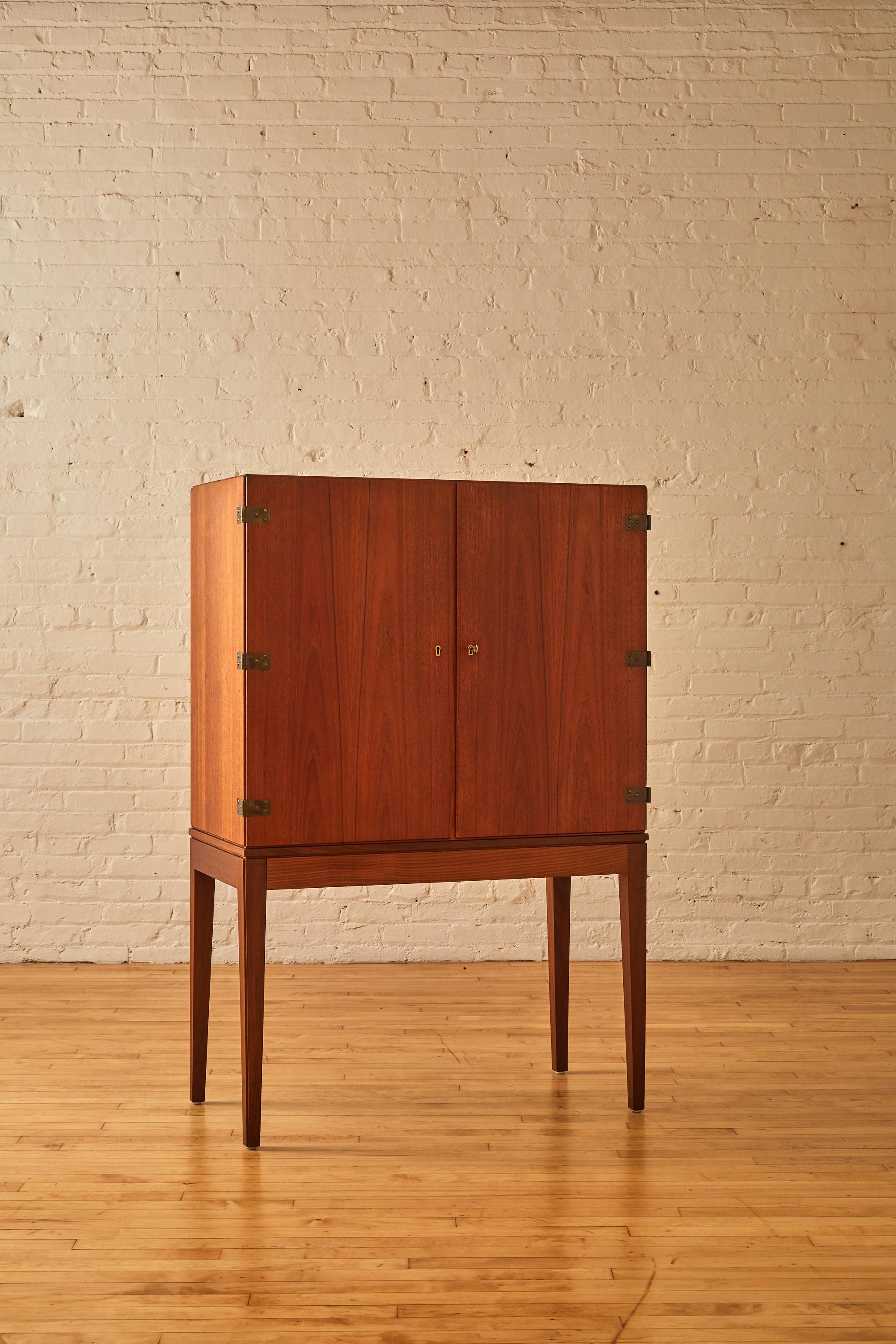 Svend Langkild cabinet by Langkild Mobler with a fitted interior featuring pull-out drawers and shelves with exposed dovetailed joints. The chest sits on tapered legs. (one key included).

