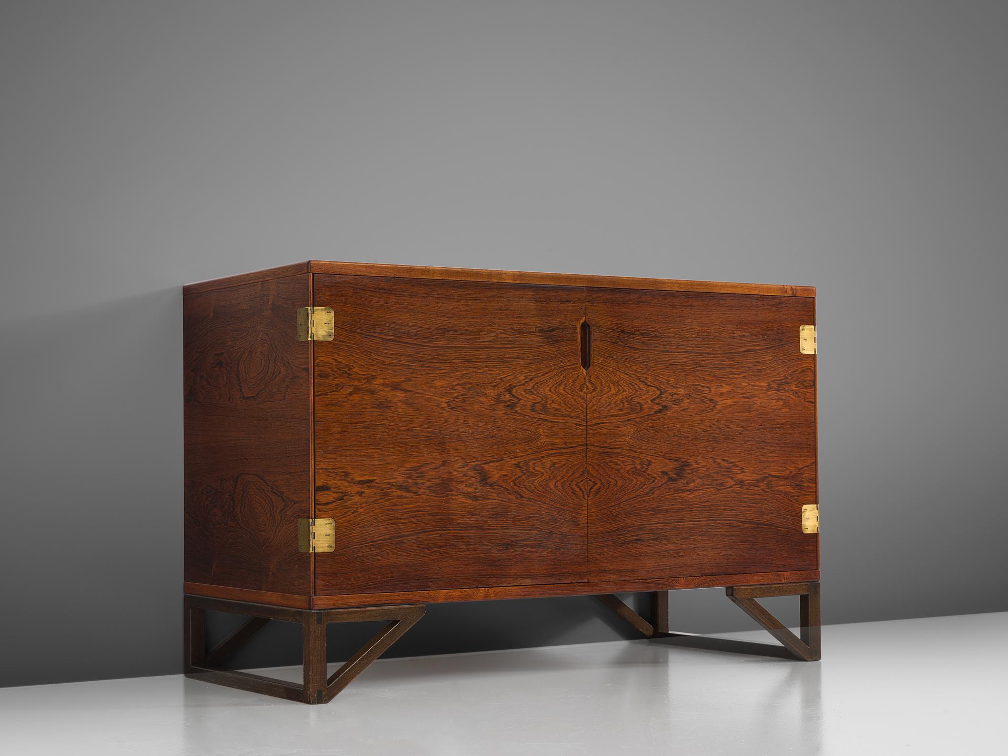 Svend Langkilde for Lankilde Møbler, cabinet, rosewood and brass, Denmark, 1950s. 

Modest and refined rosewood cabinet designed by Svend Langkilde, produced by Langkilde Møbler. This sideboard is equipped with Langekilde's signature graphic door