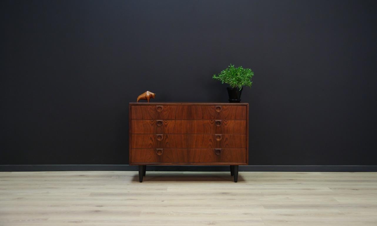 Original chest of drawers from the 1960s-1970s, Danish design. A Minimalist form designed by Svend Langkilde. Surface covered with rosewood veneer. The furniture has four capacious drawers. Preserved in good condition (small bruises and scratches) -