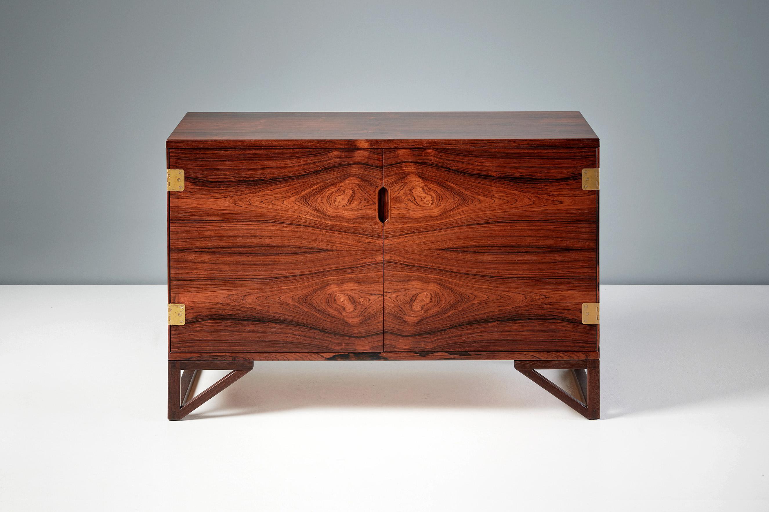 Sven Langkilde - Rosewood Cabinet

2-door cabinet made from exquisite rosewood designed by Sven Langkilde and produced by his own company Langkilde Mobler. The internal space is made from solid and veneered African mahogany with a mix of shelves and