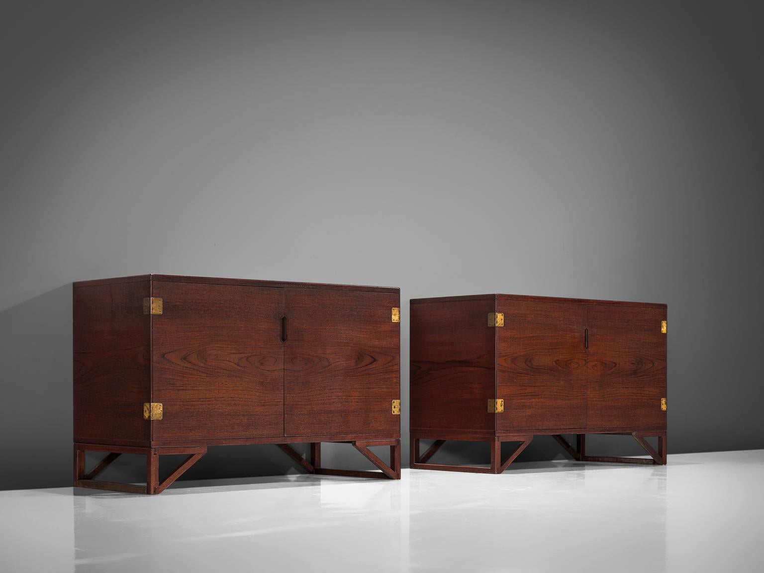 Svend Langkilde for Illum Bolighus, set of 2 cabinets in teak and brass, Denmark, 1965.

Modest and refined rosewood cabinets designed by Svend Langkilde, produced by Illums Bolighus. These sideboards are equipped with Langekilde's signature