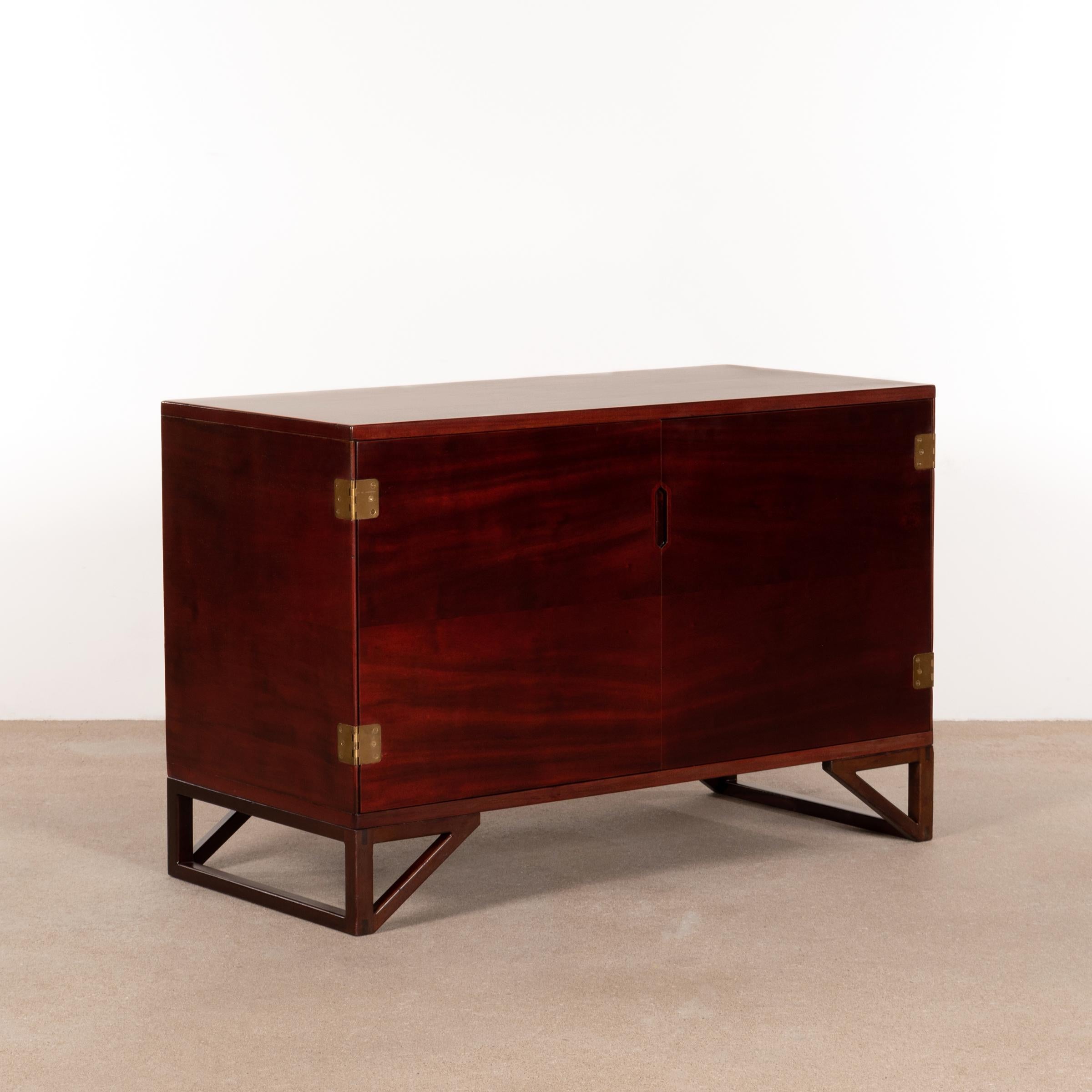 Elegant cabinet by Svend Langkilde by Langkilde Møbler for Illums Bolighus, Denmark. Behind the two doors are four drawers and one shelf. Mahogany veneer and brass hinges. The cabinet has beautiful details and displays great craftmanship. All in