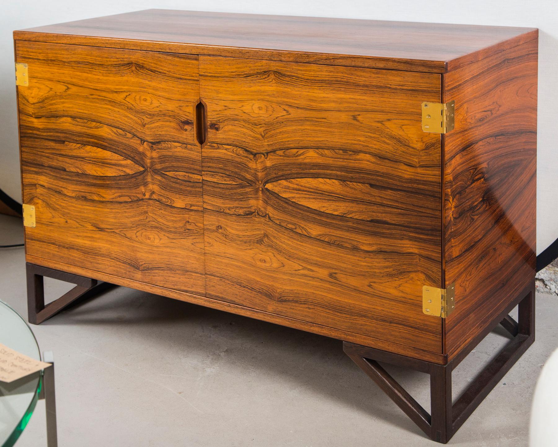 Elegant cabinet or chest in rosewood with brass hardware. Designed by Svend Langkilde M.A.A. Made in Denmark, circa 1960s. Great original condition.