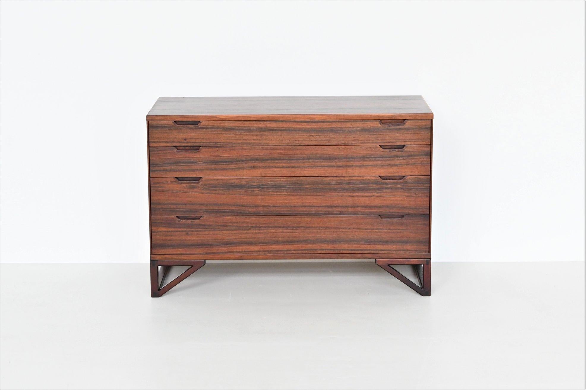 Stunning and refined chest of drawers designed by Svend Langkilde for Illums Bolighus, Denmark 1960. This well-crafted cabinet is executed in amazingly grained veneered rosewood supported by solid hardwood legs. These beautiful legs emphasize the