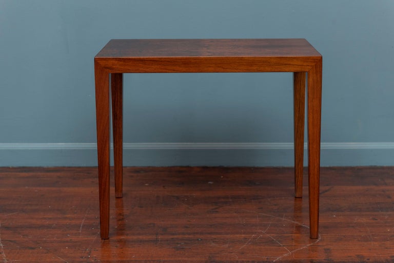 Svend Langkilde design rosewood veneer side or end table. Simple elegant side table in beautiful rosewood, newly refinished and labeled. The color changes depending on the angle of light reflected and opposing direction of the veneer creates