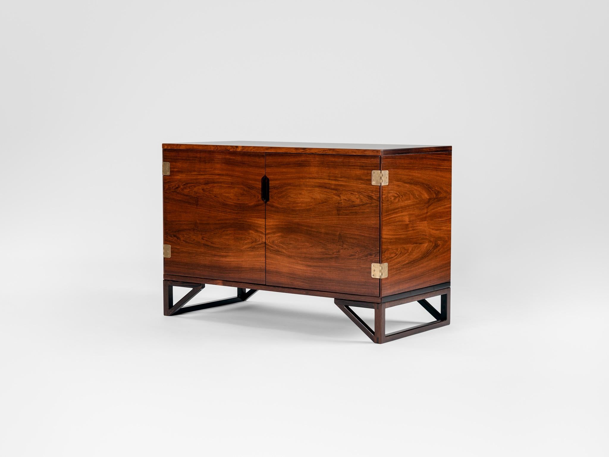 Beautiful sideboard made of rosewood designed by Svend Langkilde and produced by Langkilde Mobler. 

With two doors. Inside two shelfs on the left and 4 trays. The height on both shelfs and trays can be adjusted. 

Back of the inside is
