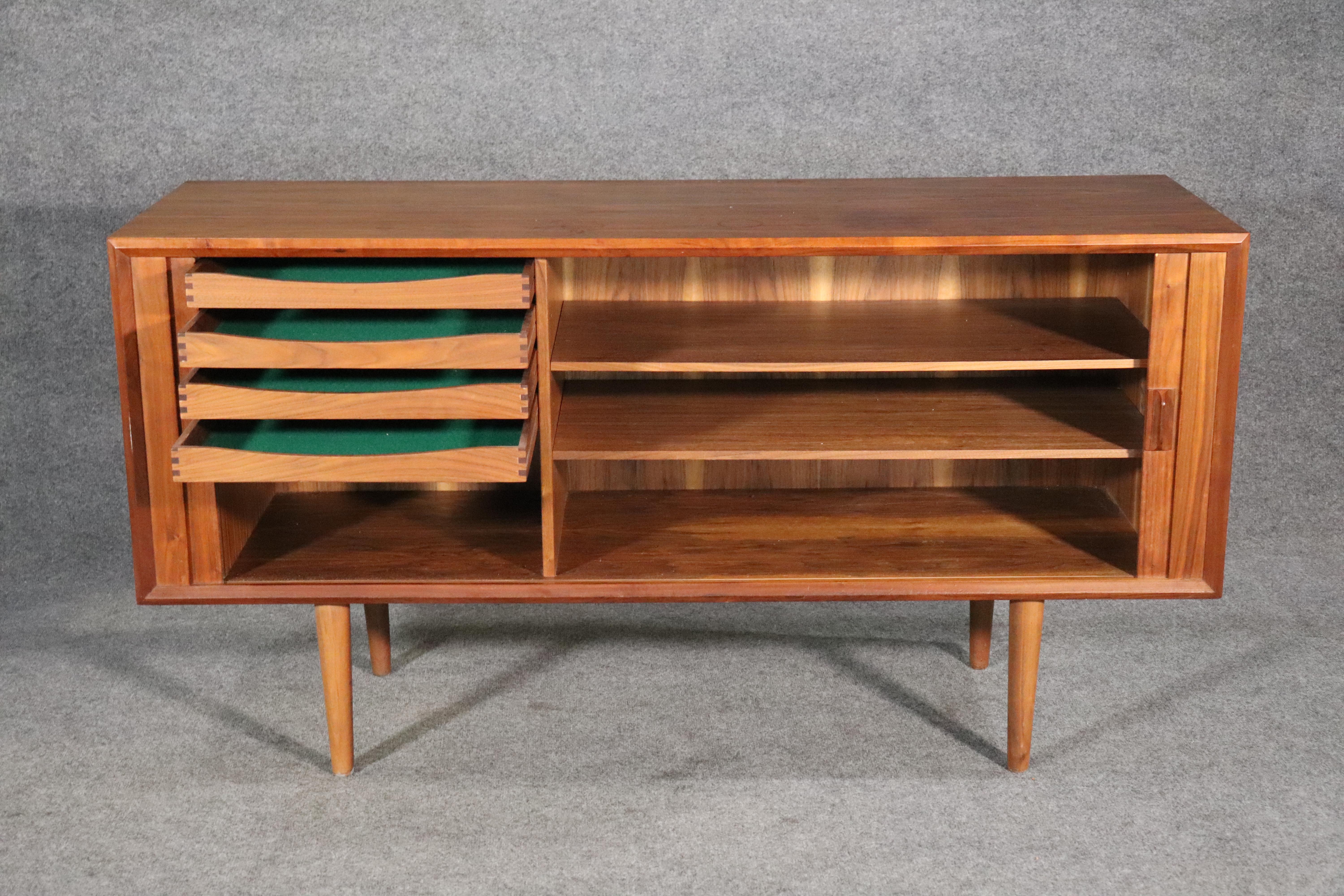 Danish mid-century modern sideboard designed by Svend Larsen. Beautiful use of teak grain, with a finished back, tambour doors, and ample storage for living or dining room.
Please confirm location NY or NJ