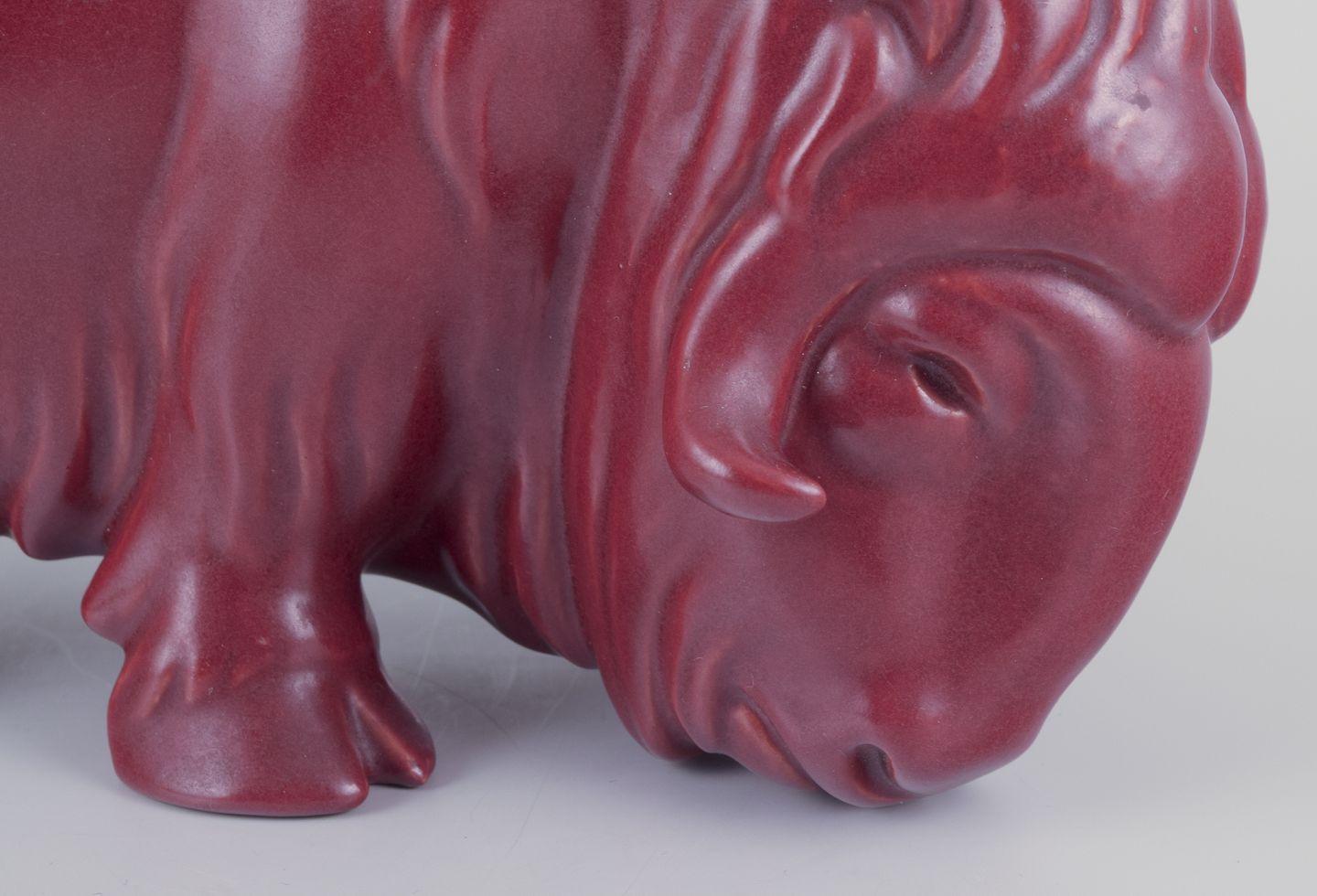 Pre-owned goods are exempt from import duties for U.S. customers. 
Therefore, no import tariffs will be applicable to your purchase.

Svend Lindhart (1898-1989), Danish ceramicist, own workshop. 
Musk ox in ceramic.
Oxblood glaze.
Dating: Ca.