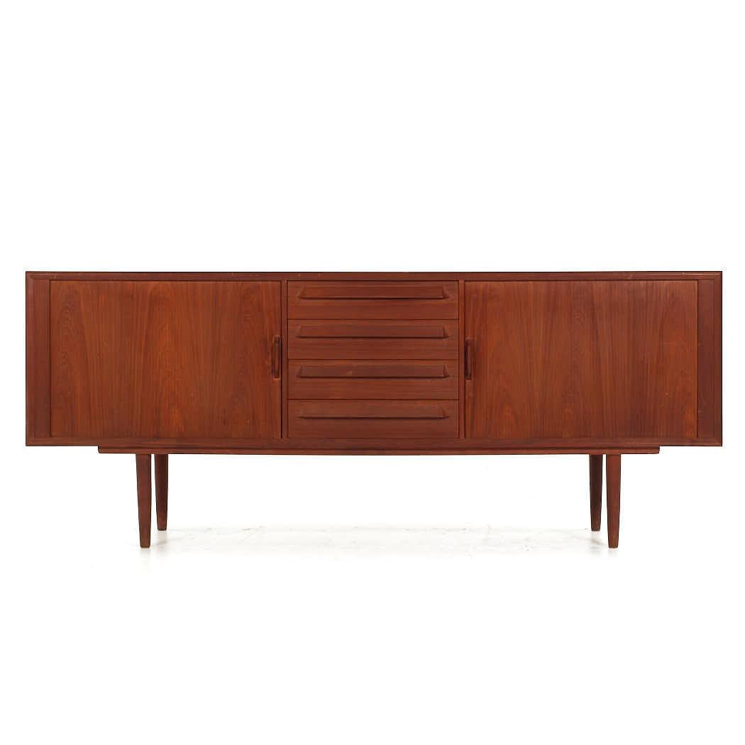 Svend Madsen Style Mid Century Danish Teak Tambour Door Credenza

This credenza measures: 79.75 wide x 19 deep x 32 inches high

All pieces of furniture can be had in what we call restored vintage condition. That means the piece is restored upon