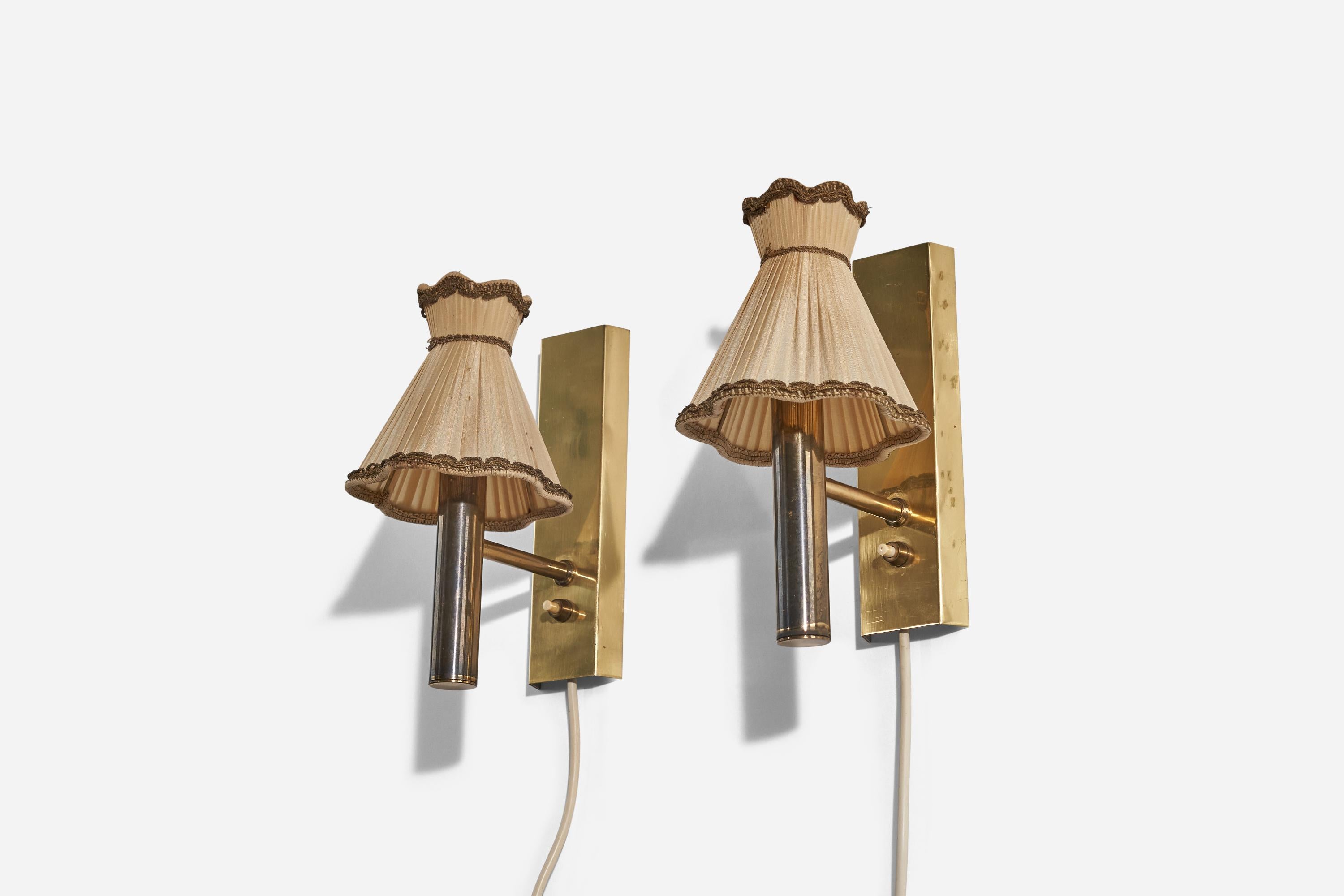 A pair of brass and fabric wall lights designed and produced by Svend Mejlstrøm, Norway, c. 1960s. 

Sold with Lampshade. 
Stated dimensions refer to the Sconce with the Shade. 
Dimensions of back plate (inches) : 7.87 x 2.31 x 0.68 (H x W x D).
