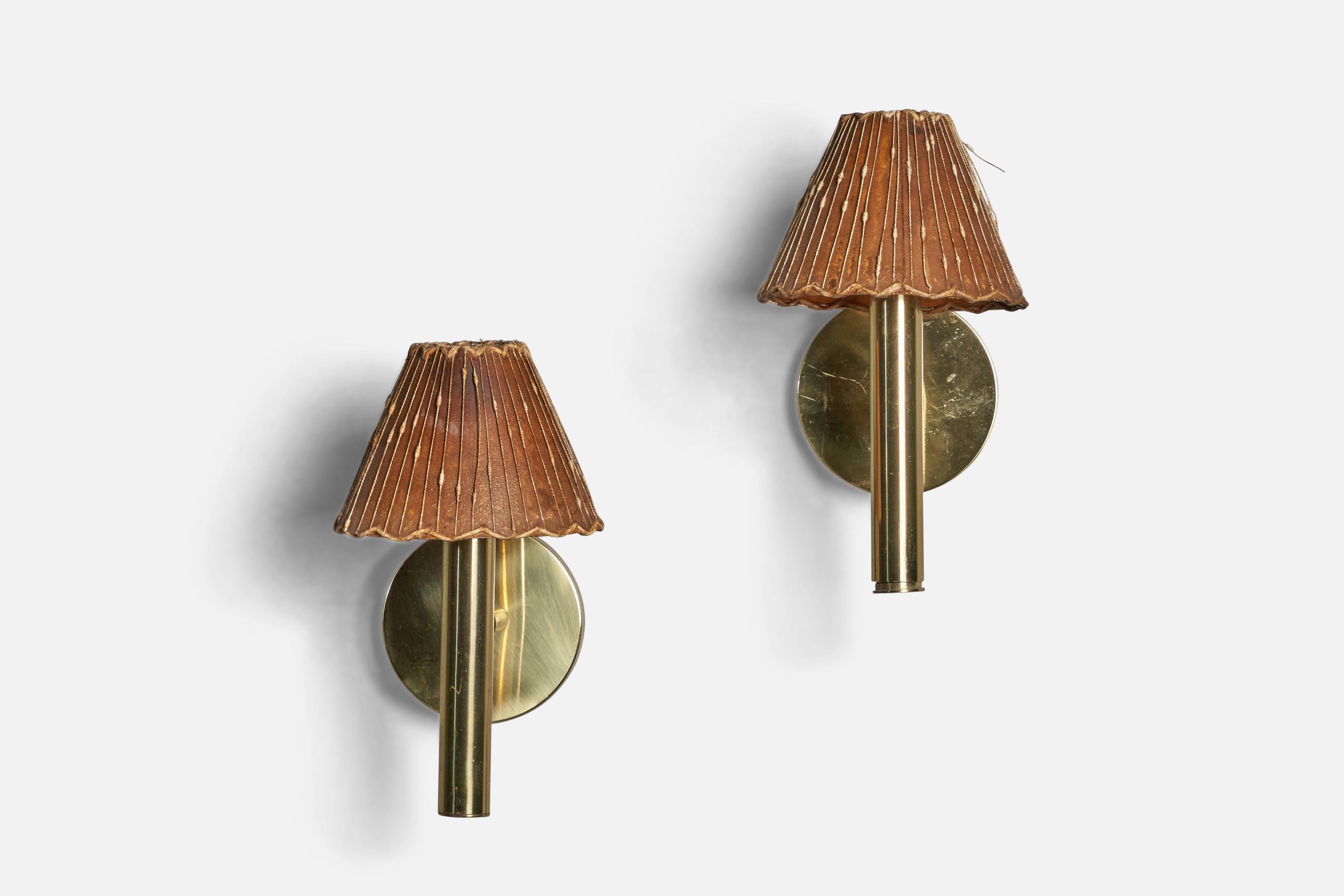 A pair of brass and parchment paper wall lights designed by Svend Mejlstrøm and produced by MS Belysning, Norway, c. 1960s.

Overall Dimensions (inches): 9” H x 5” W x 6.75” D
Back Plate Dimensions (inches): 3.95” Diameter x 0.8” D
Bulb
