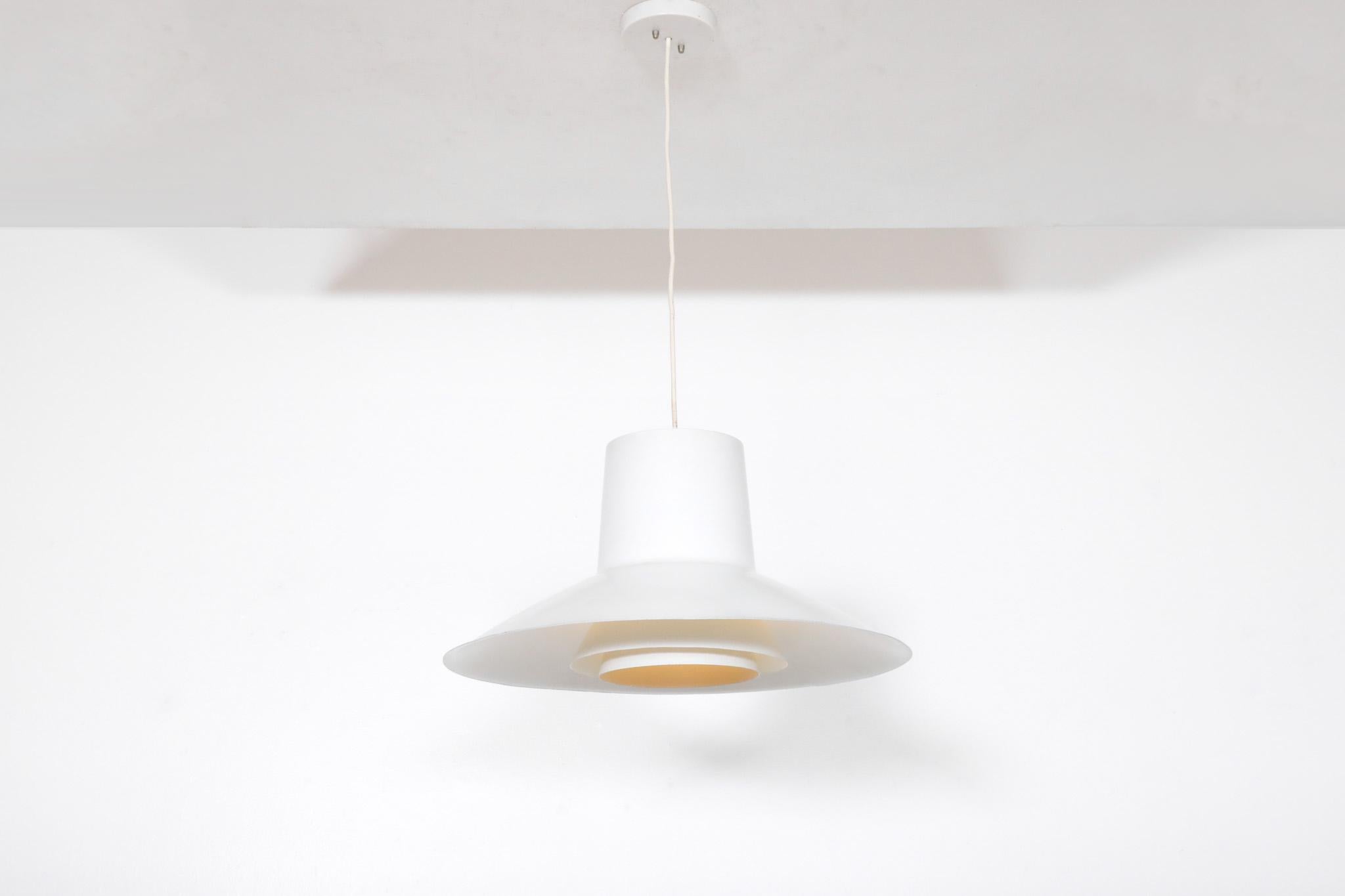 Mid-Century 'Auditorie 2' pendant by Svend Middelbo for Nordisk Solar, 1970s. This mid size configuration is apart of the classic 'Auditorie series' trio. White enameled metal frame with 2 layered shades and matching ceiling mount hardware. In
