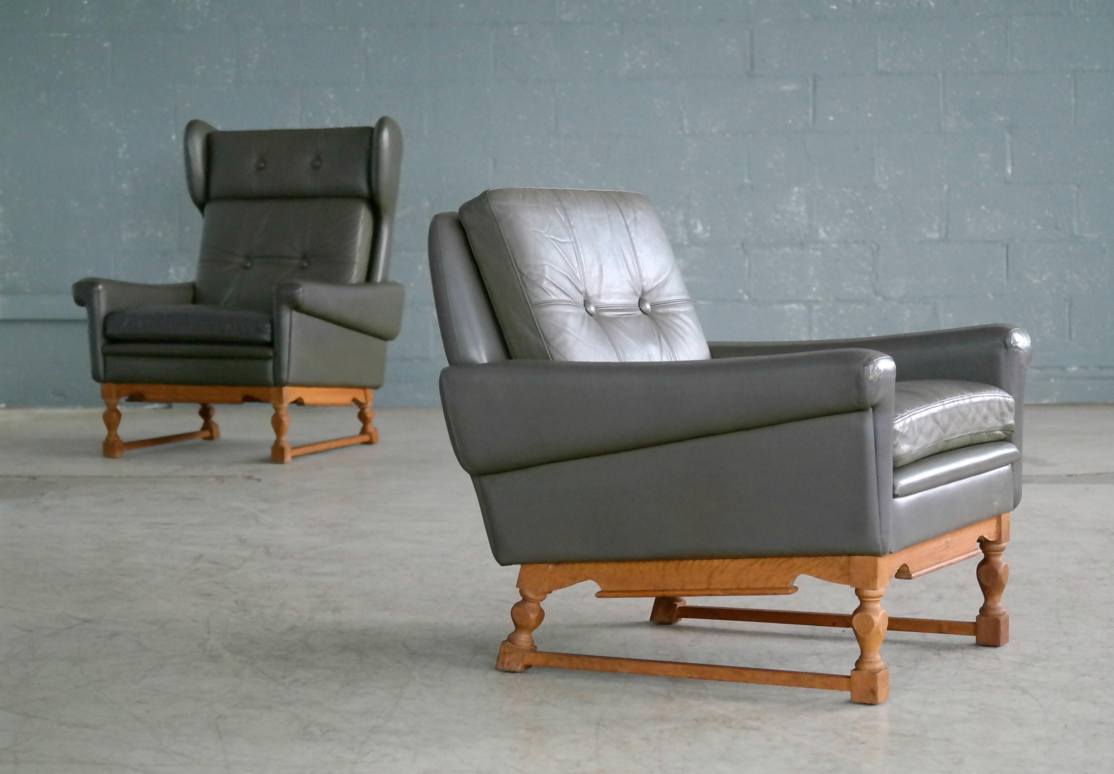 Super stylish pair of 1960s lounge chairs in gray green leather by Sven Skipper. The chairs are one of Sven Skipper's classic well-known and sought after designs but with a certain twist as the pair has been supplied with custom made bases of
