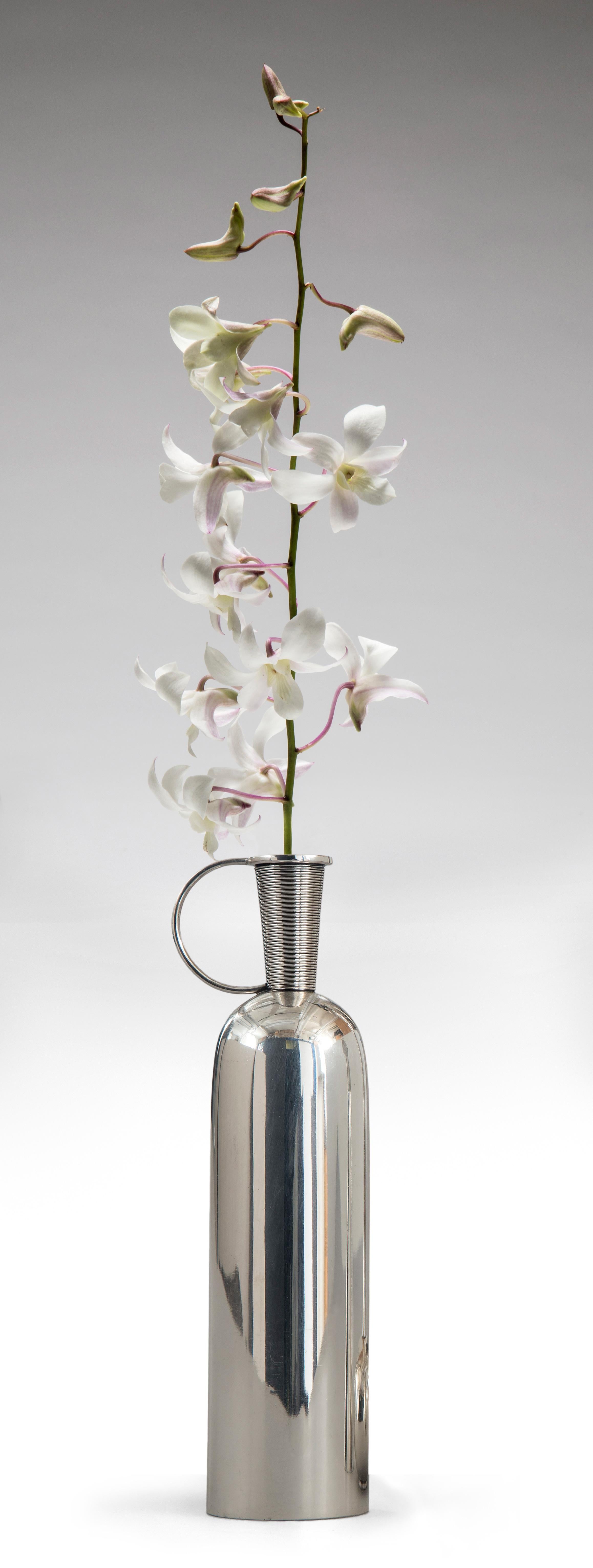 A very fine example of mid century Danish silver. The striated neck with a loop handle above a bottle-form body. Marked: F. Hingleberg Denmark Aarhus

A total of two vases by Svend Weihrach for Frantz Hingelberg available and sold separately. 