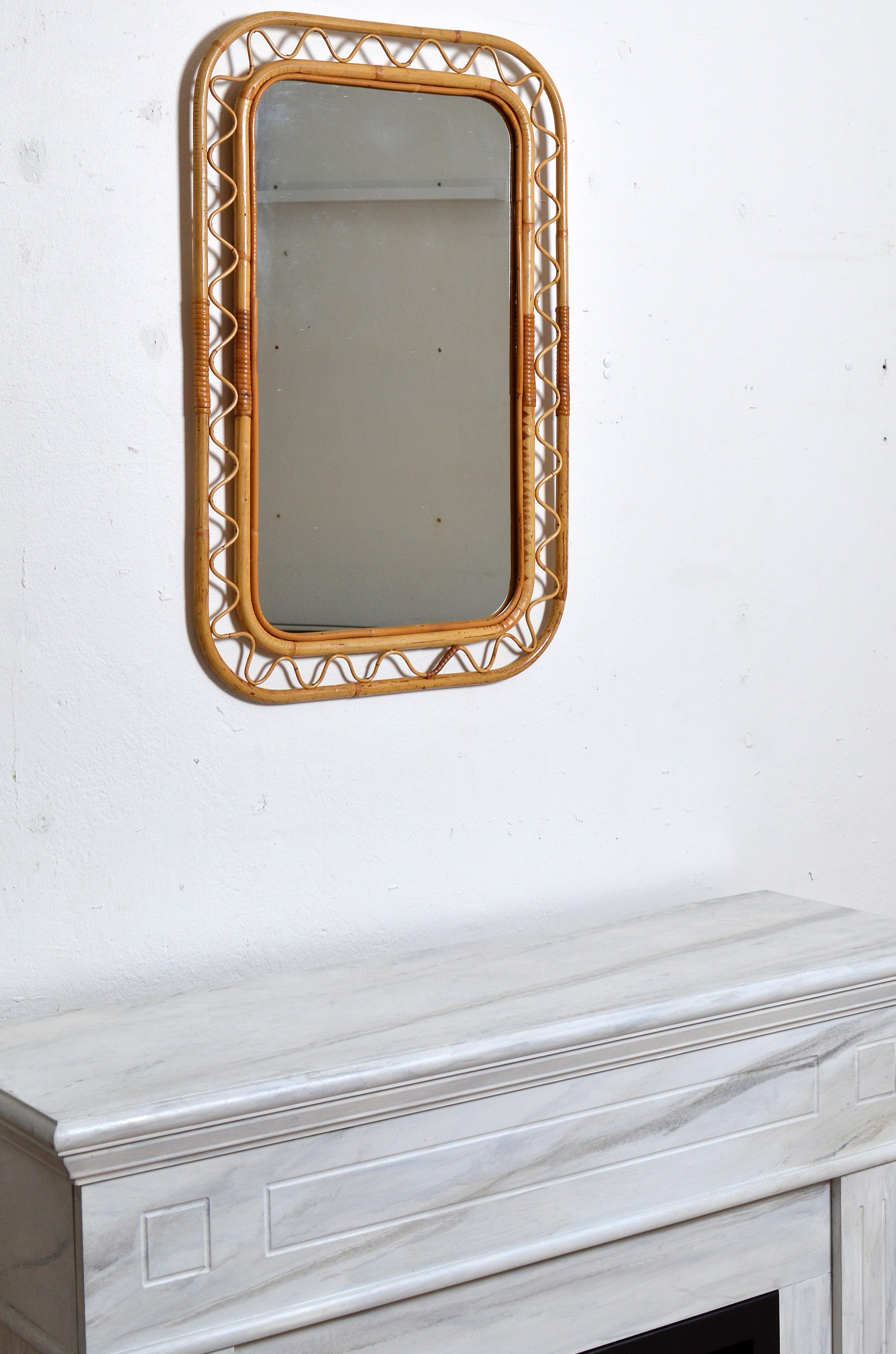 A Large wall mirror retailed by Svenskt Tenn the iconic Swedish firm founded by Estrid Ericson and creatively led by Josef Frank. In finely braided wicker / rattan / cane and bamboo. Excellent vintage condition. 

Other designers of the period
