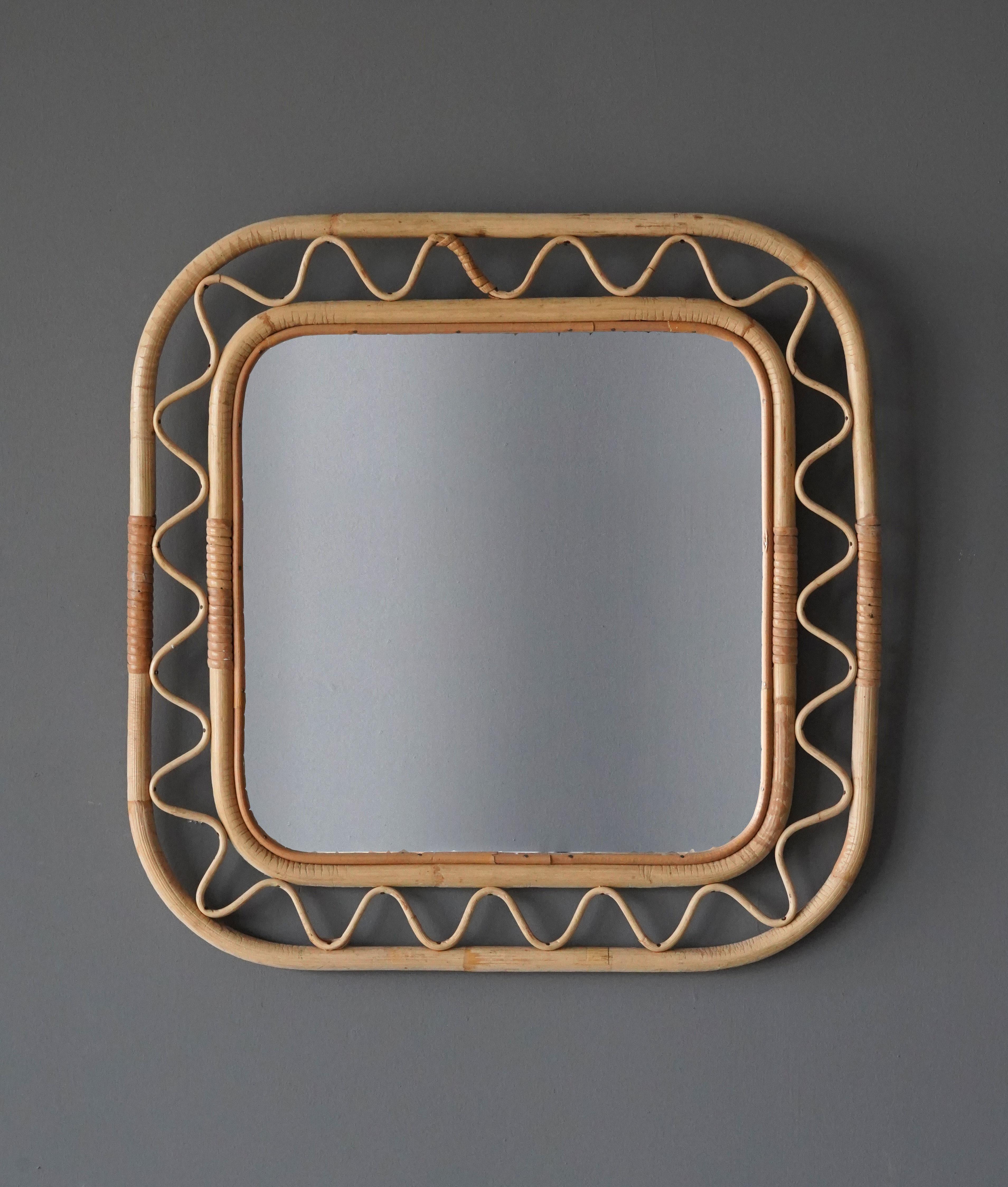 An organic mirror, of unknown Swedish production. This mirror retailed by Svenskt Tenn, the iconic Swedish firm founded by Estrid Ericson and creatively led by Josef Frank. 

In finely braided wicker / rattan / cane and bamboo.

Other designers