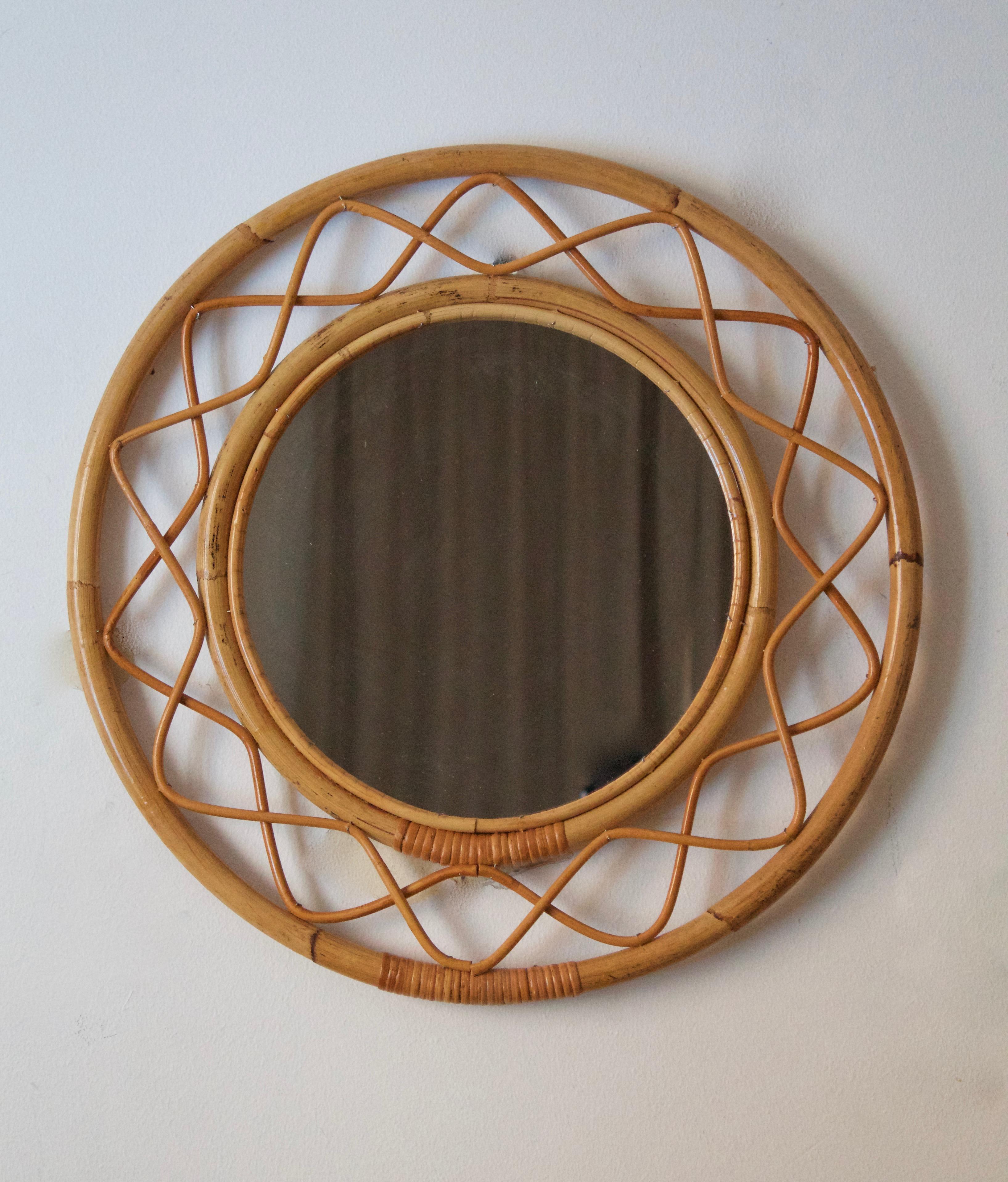An organic mirror, of unknown Swedish production. This mirror retailed by Svenskt Tenn, the iconic Swedish firm founded by Estrid Ericson and creatively led by Josef Frank. 

In finely braided wicker / rattan / cane and bambo.

Other designers
