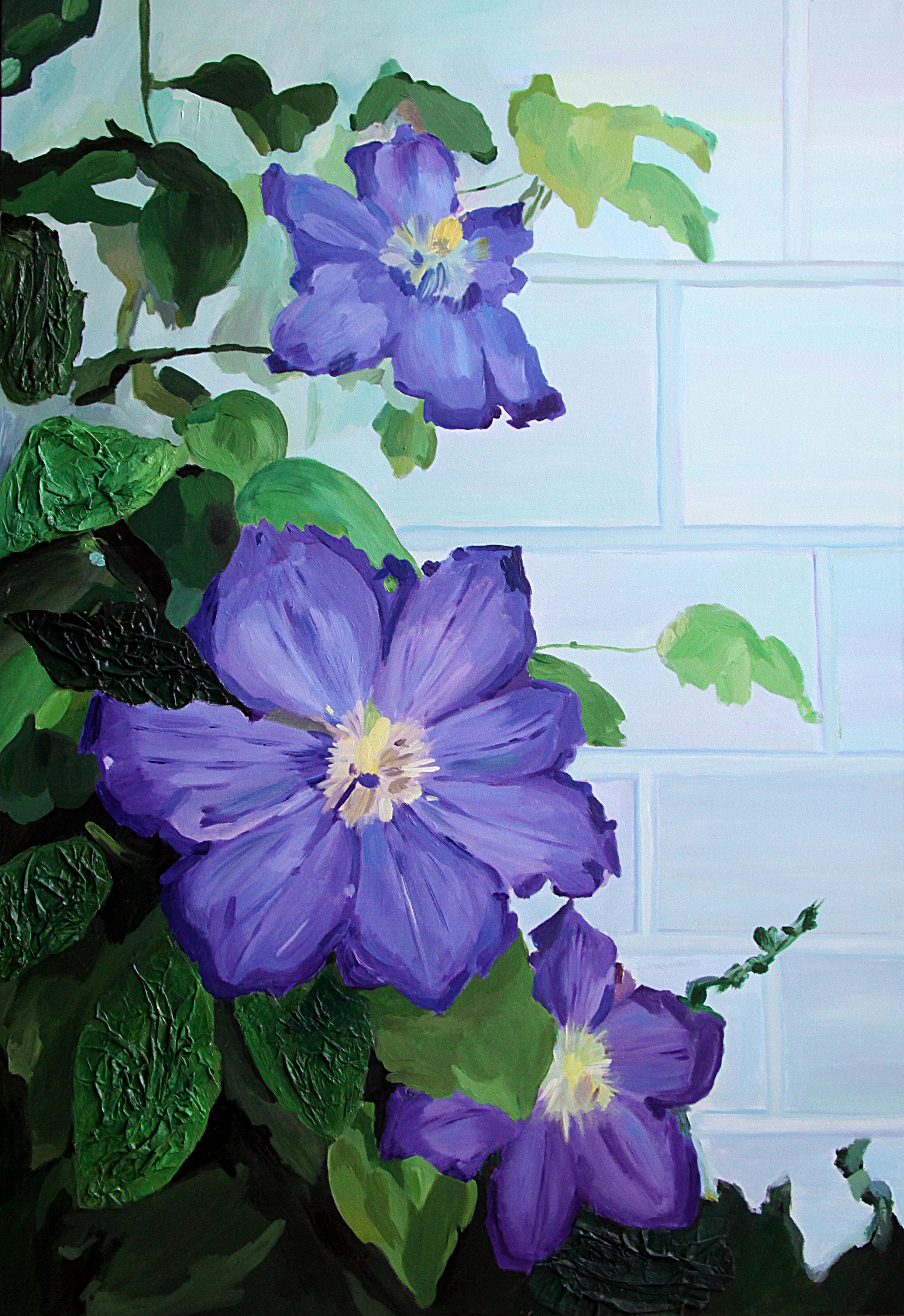 Flores de clemátide a lo largo de un muro de ladrillo