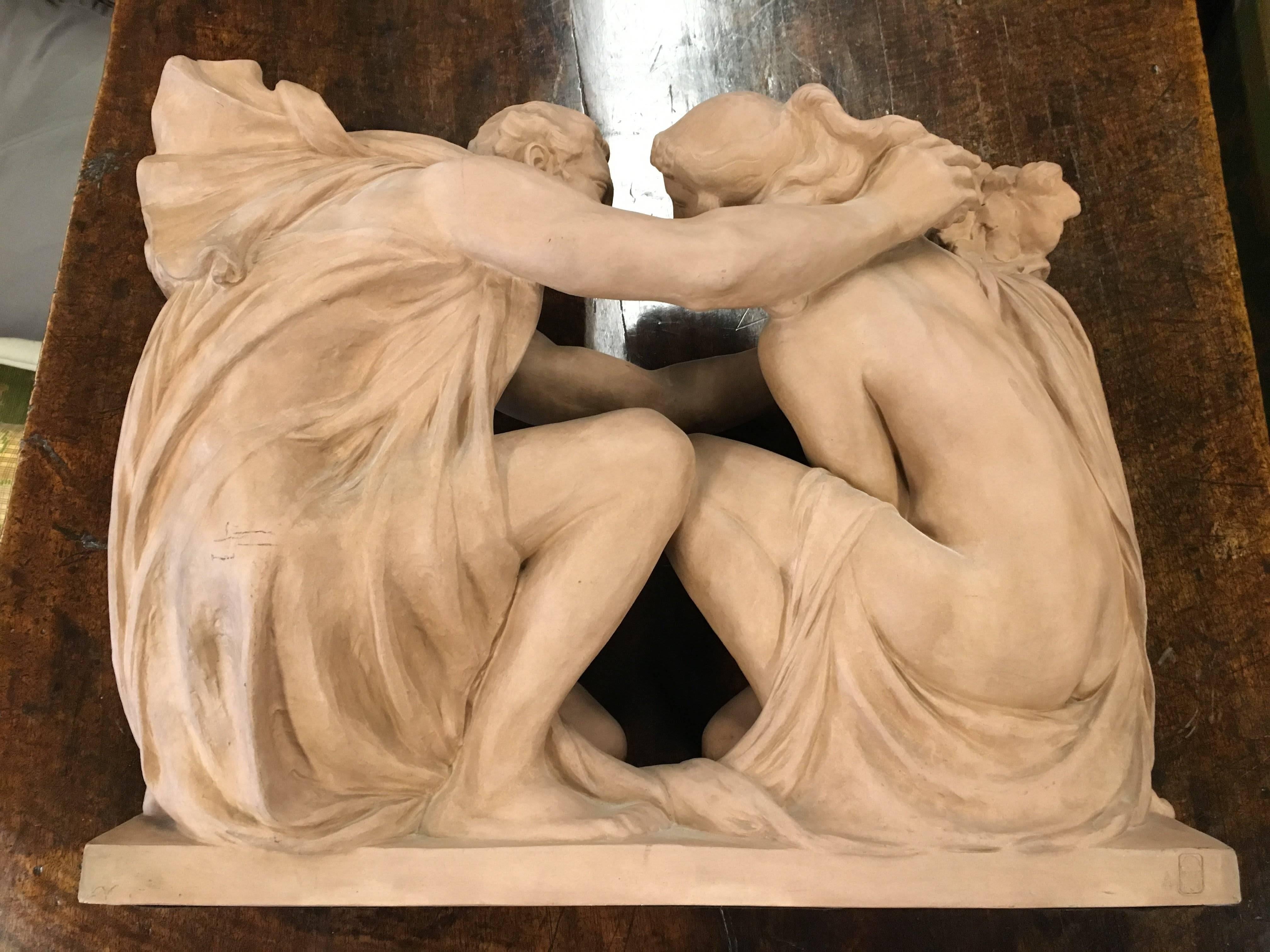 Dramatic nude male and female forms in artistic struggle/taunt for grapes in terracotta by famed sculptor, Richard Guino, for Manufacture nationale de Sèvres. Signed by the artist and visibly stamped with the maker's mark on the base. From France,