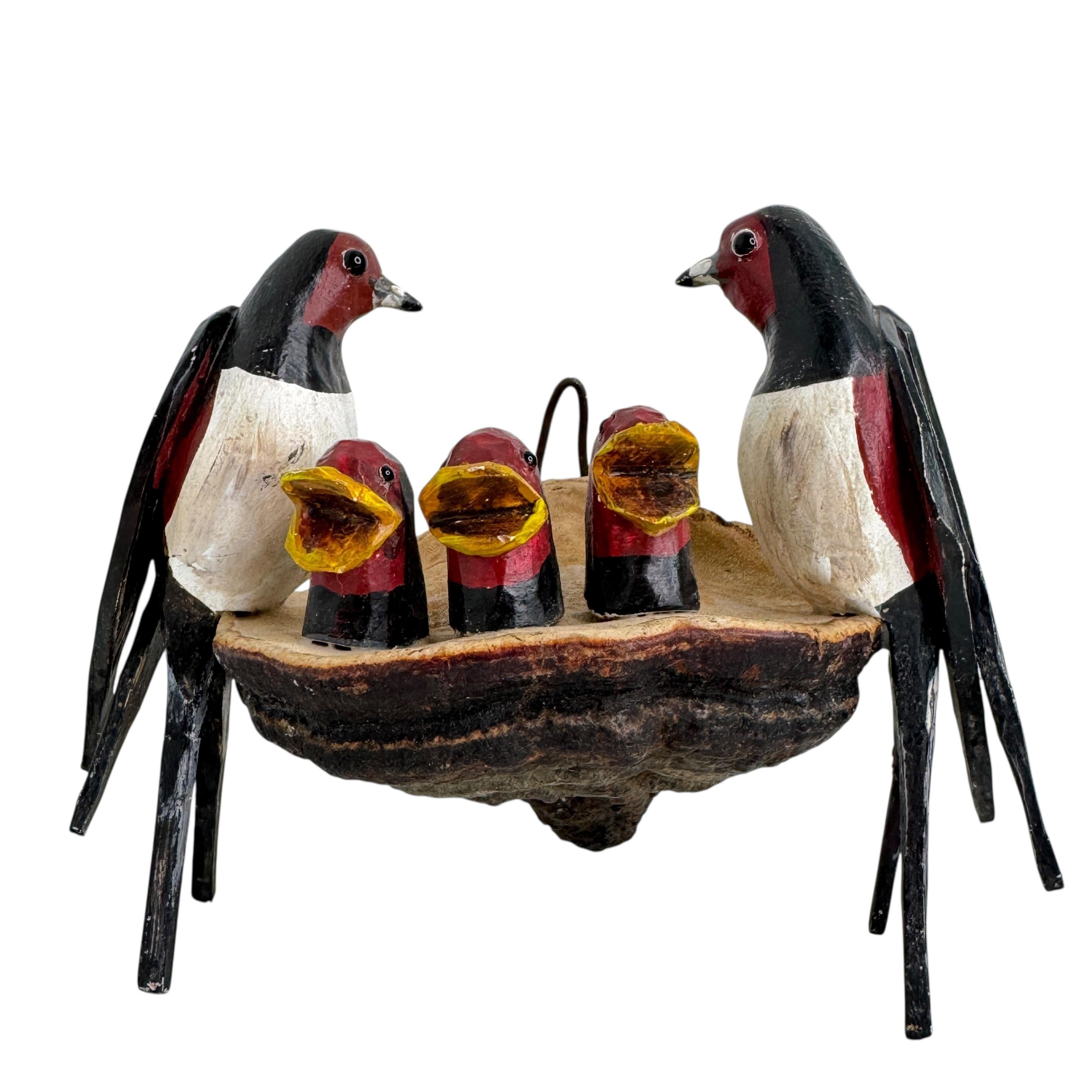 A beautiful, cute Austrian piece from the early 20th century. Birds carved from wood, polychrome painted, with glass eyes, nest-shaped, depicting naturalistic parents with three young.
The tradition of these birds, known in Austria as 
