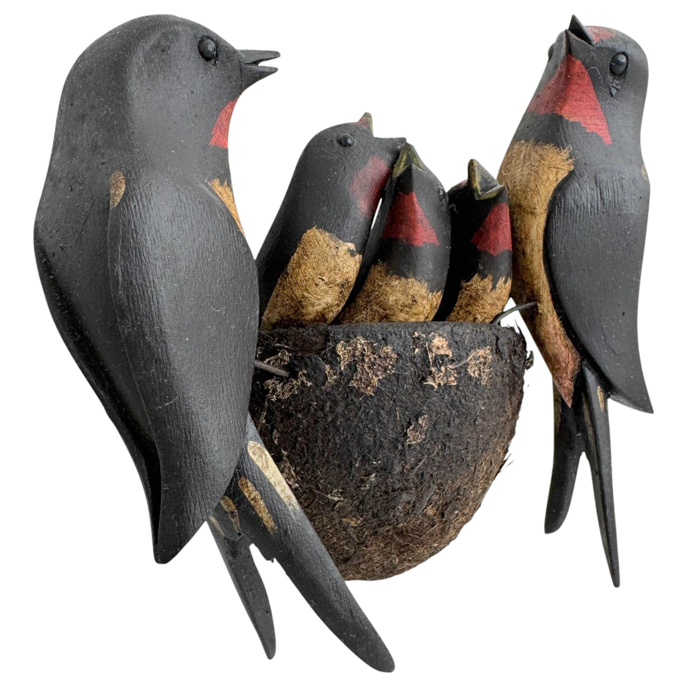 A beautiful large size Austrian early 20th century, carved wood, polychrome painted, wire feet, glass eyes, wooden base in nest shape naturalistically covered with dirt, slightly crumbled, parents with three young.
The tradition of these in Austria