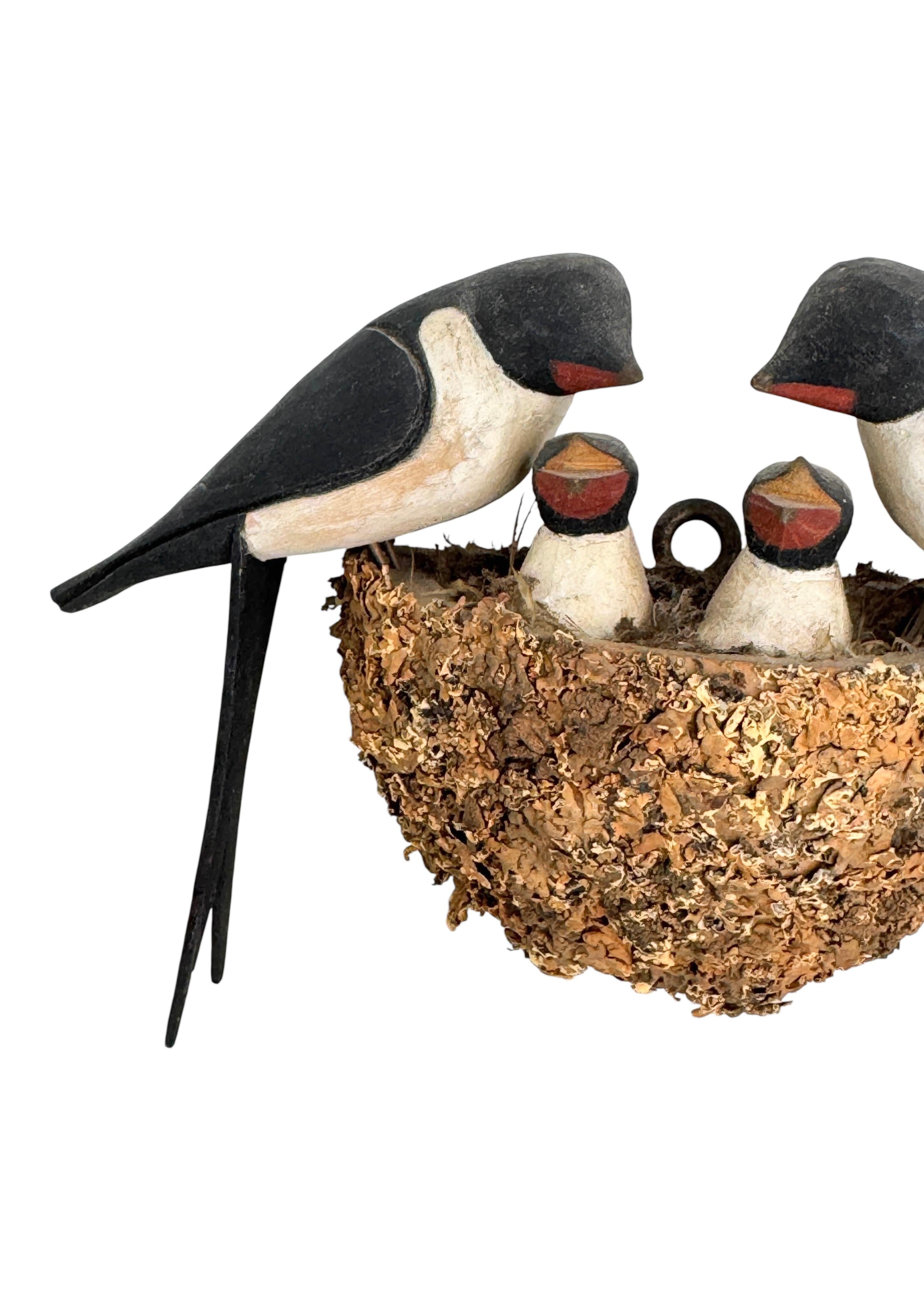 A beautiful Austrian early 20th century, carved wood, polychrome painted, wire feet, wooden base in nest shape naturalistically covered with dirt, slightly crumbled, parents with two young.
The tradition of these in Austria called 