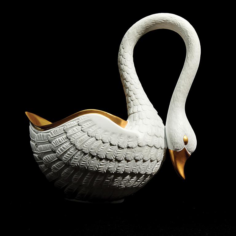 Inspired by the beautifully detailed porcelain of the 19th century Empire period, the Swan bowl nods to antiquity with modern grace. From the hand-gilded 24K gold bowl to the silky feathers on the curve of the neck, each piece is a work of