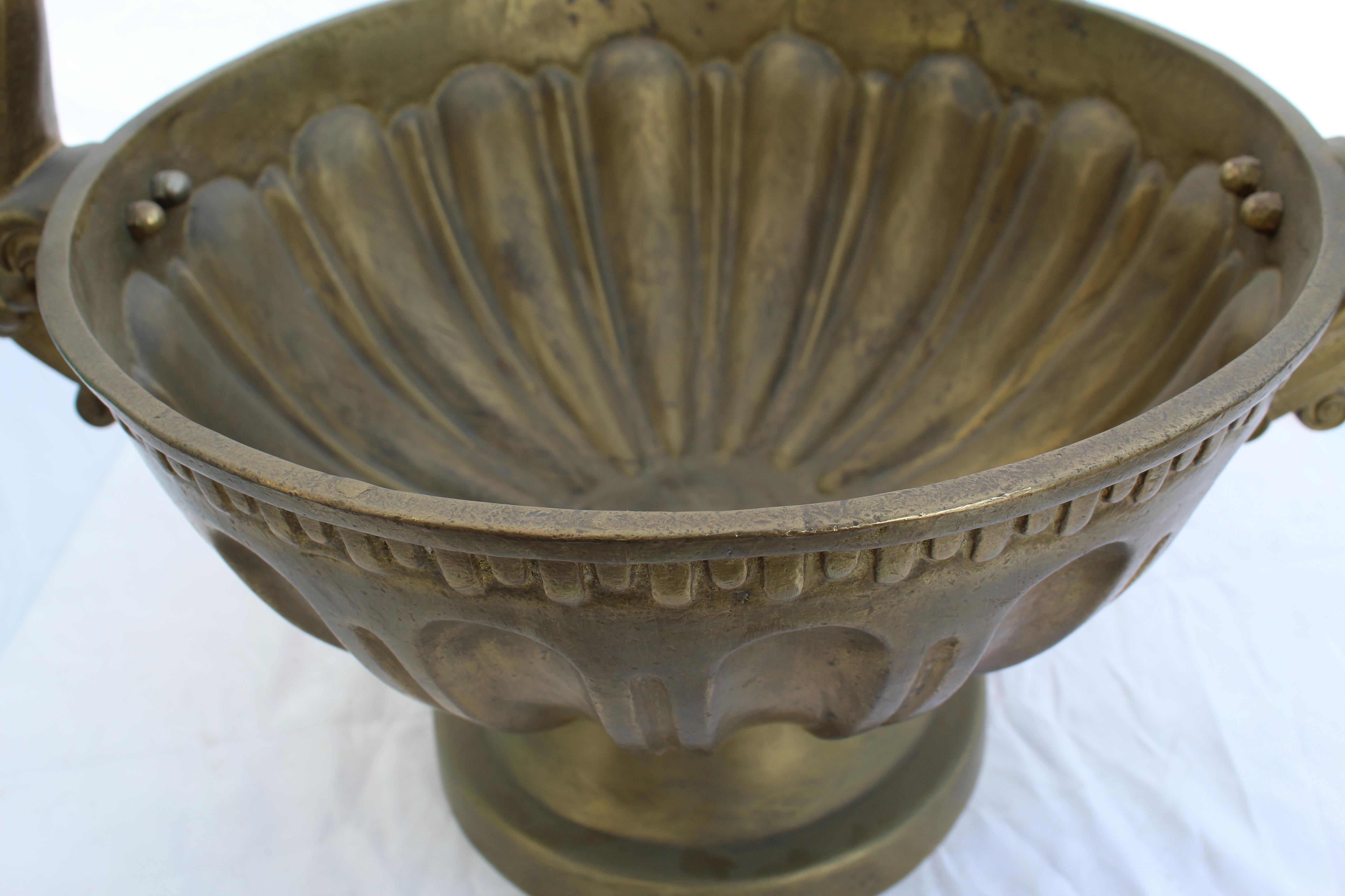 A good size centerpiece bowl. Solid cast brass with an antique finish, heavy casting. Double handles. About 16 