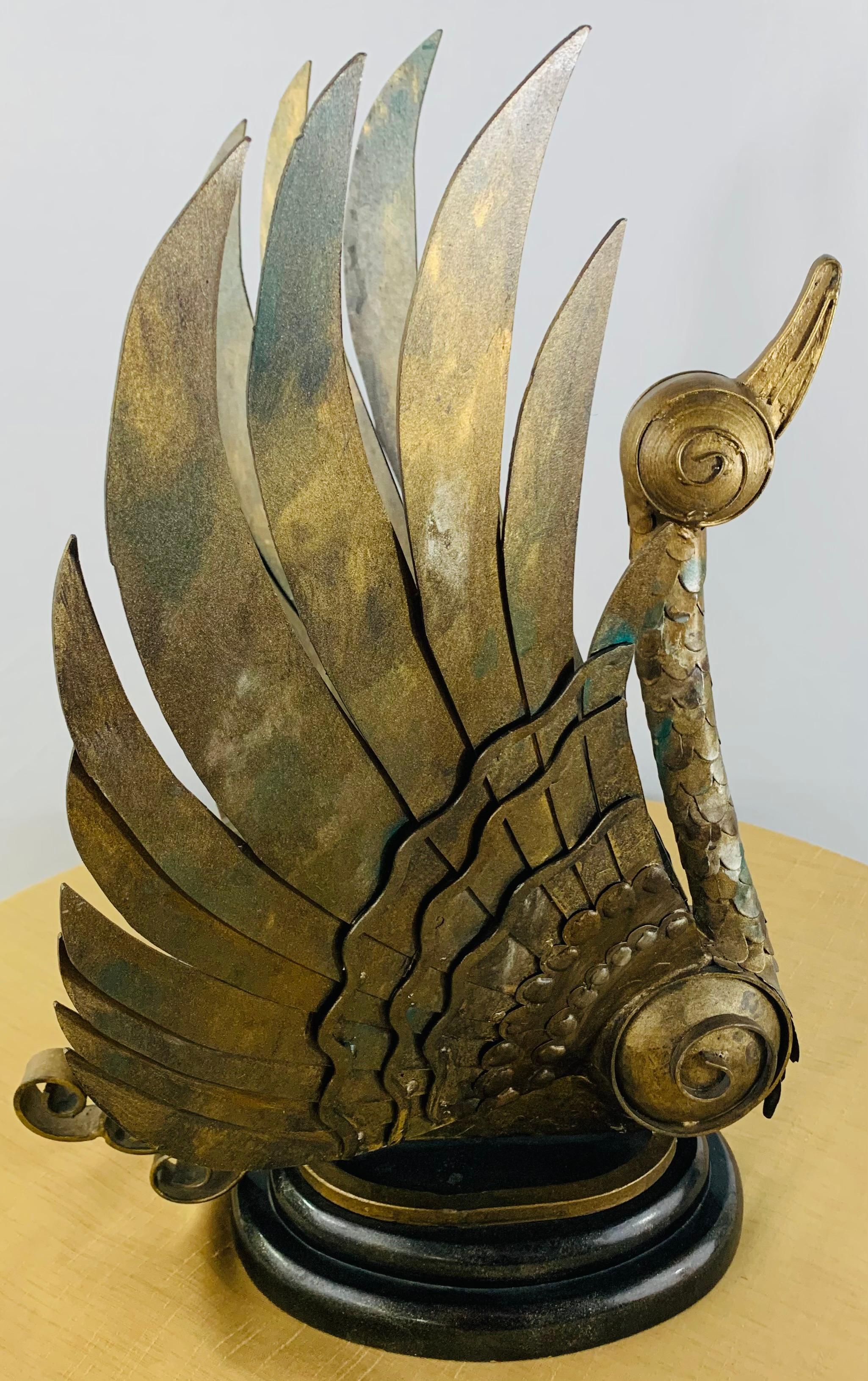 A unique and highly decorative pair of Brutalist style swan statues in bronze both in a takeoff position. The wings are finely. Carved displaying amazing details with scrolls design. Each statue seats on around wooden black base. Some display of