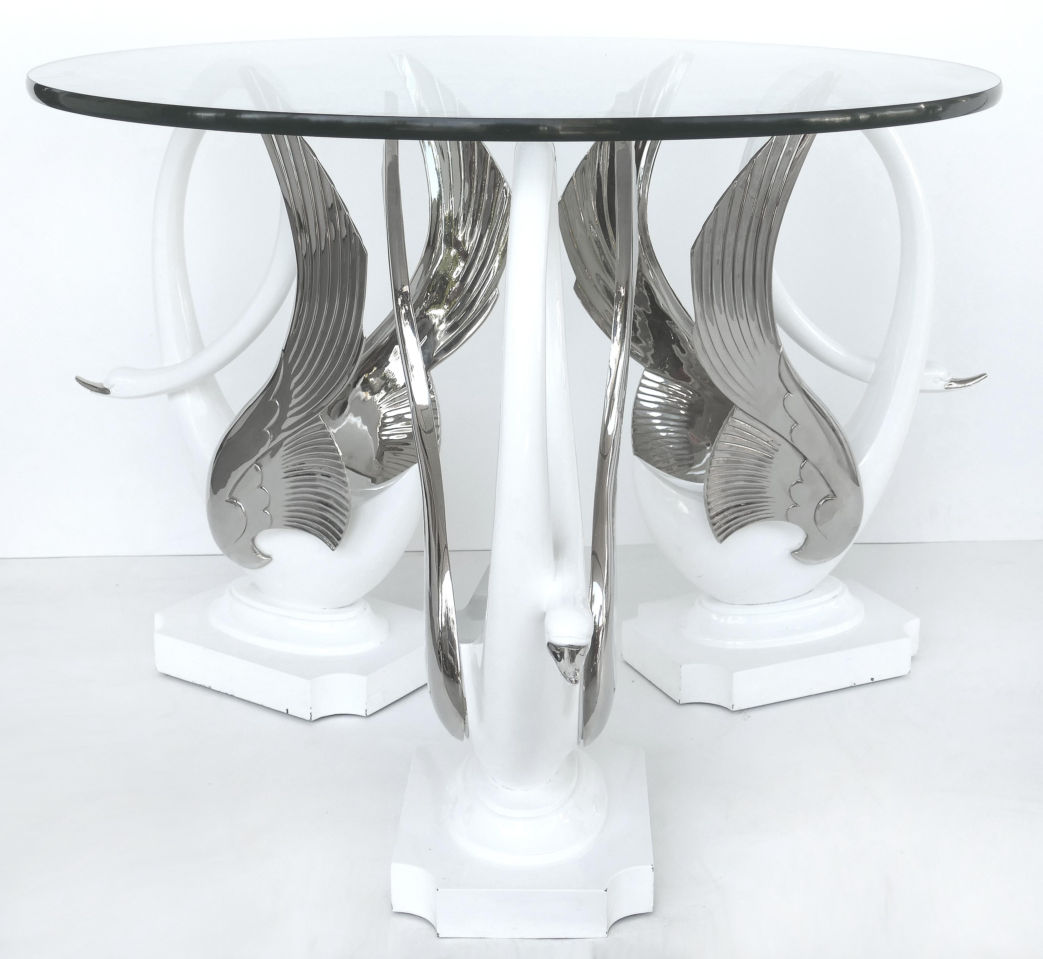 Swan center/side table in resin with silver bases and round glass top

Offered for sale is a 