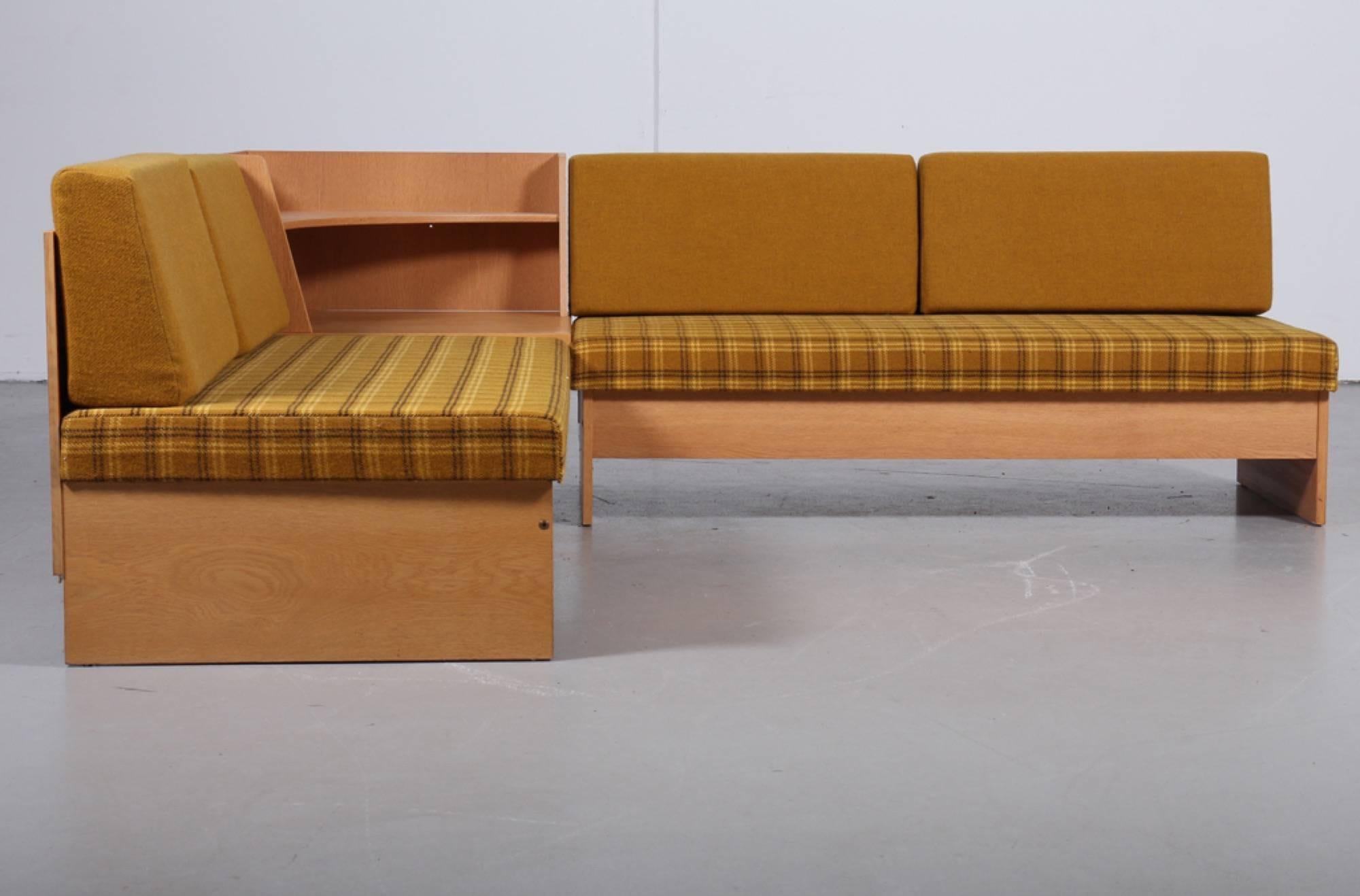 'Swan' corner sofa and armchair from Ekornes, Norway, 1970s. Made of lacquered oak, each covered with checkered wool, loose cushions, corner table, and storage above table. Measures: Chair H. 72/38. B. 65. D. 75 cm. Corner sofa H. 75/38. L. 226/226.