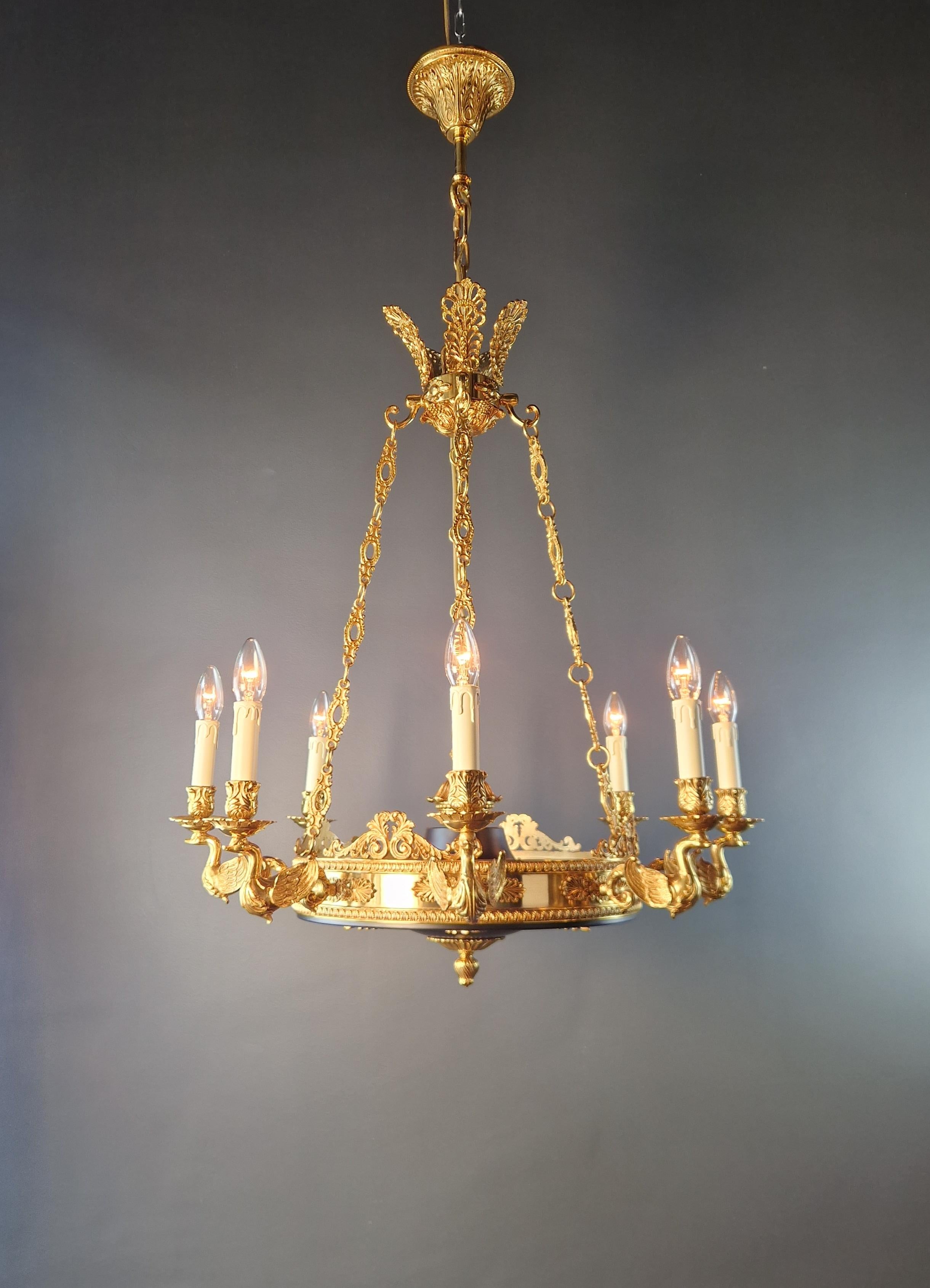 Introducing a stunning Brass Baroque Empire  Chandelier, reminiscent of the classical style of the Empire era. This is a new reproduction, and several are available, ensuring you can bring this classic beauty to your space.

Measuring a total height