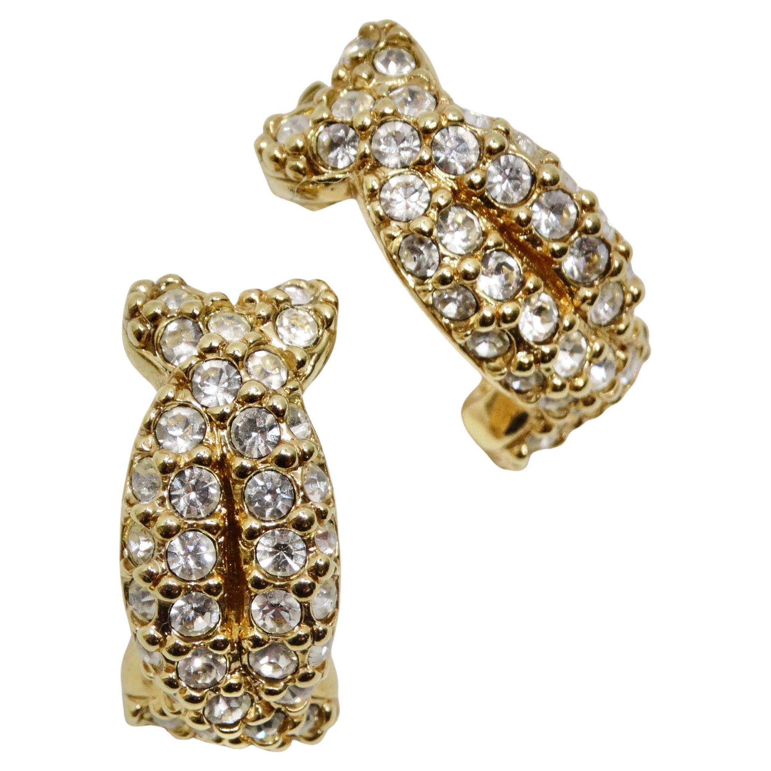 Introducing the Swarovski 18K Gold Plated Rhinestone Huggie Earrings, a classic and glamorous addition to your jewelry collection. These adorable huggie-style earrings from vintage 1990s Swarovski showcase a timeless design, featuring round clear