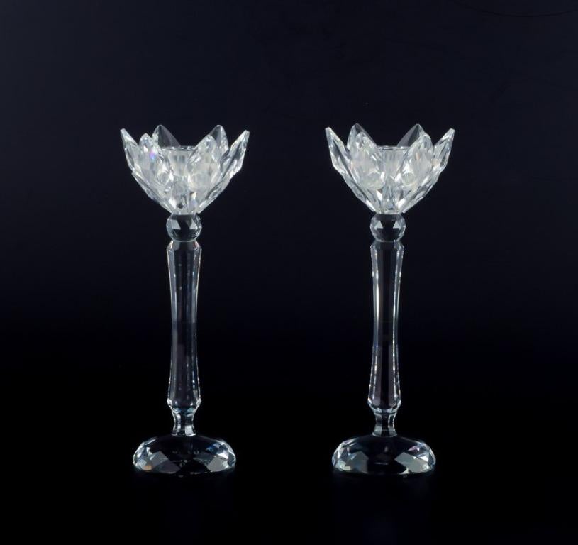 Swarovski, Austria. A pair of candle holders in faceted crystal. 
Handmade.
Circa 1970s.
Marked.
Perfect condition.
Dimensions: H 19.5 cm. x D 7.0 cm.
