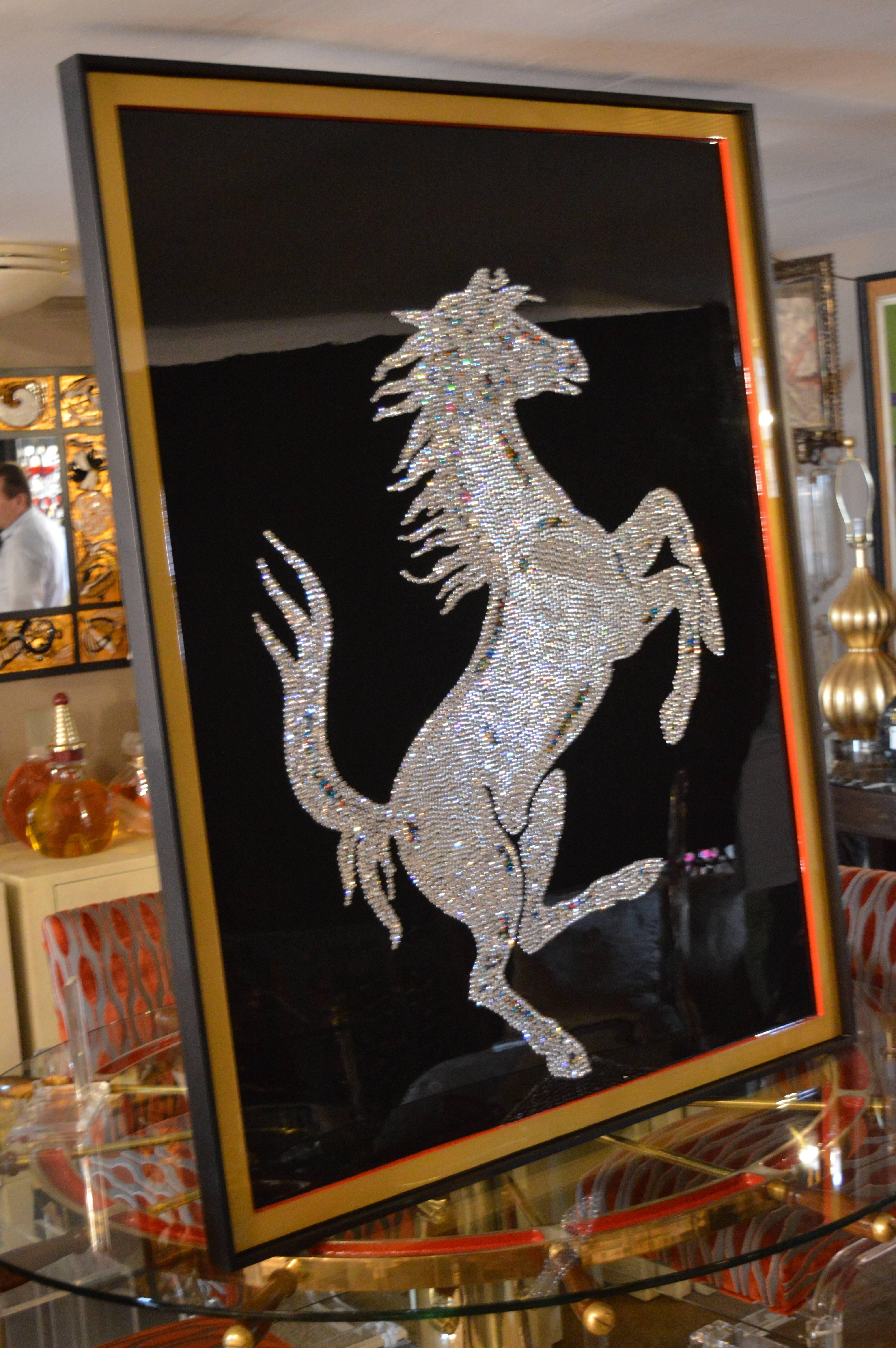 Each crystal is hand placed to replicate the horse of Ferrari, then covered in resin.