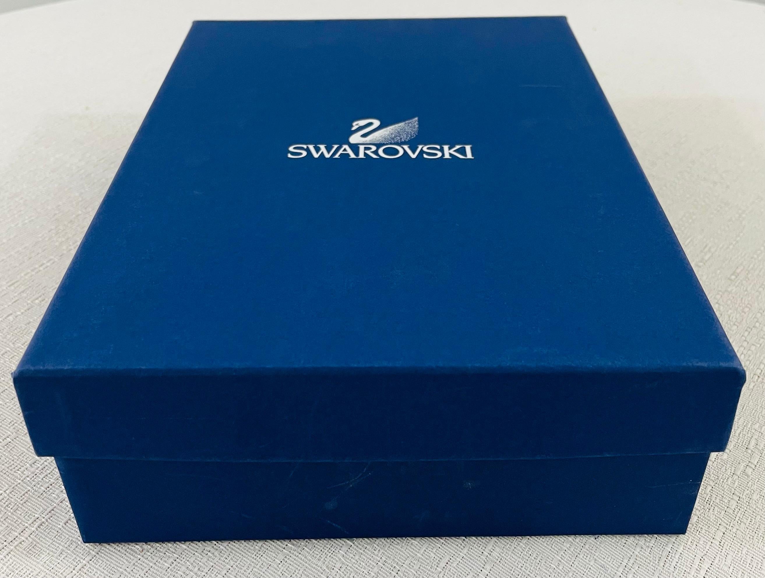 A rare retired model of Swarovski crystal figurine Christmas tree topper set presented in its original blue box with certificate of authenticity. Designed by Elke Kumar and handmade in Austria, this collectible piece was part of the 